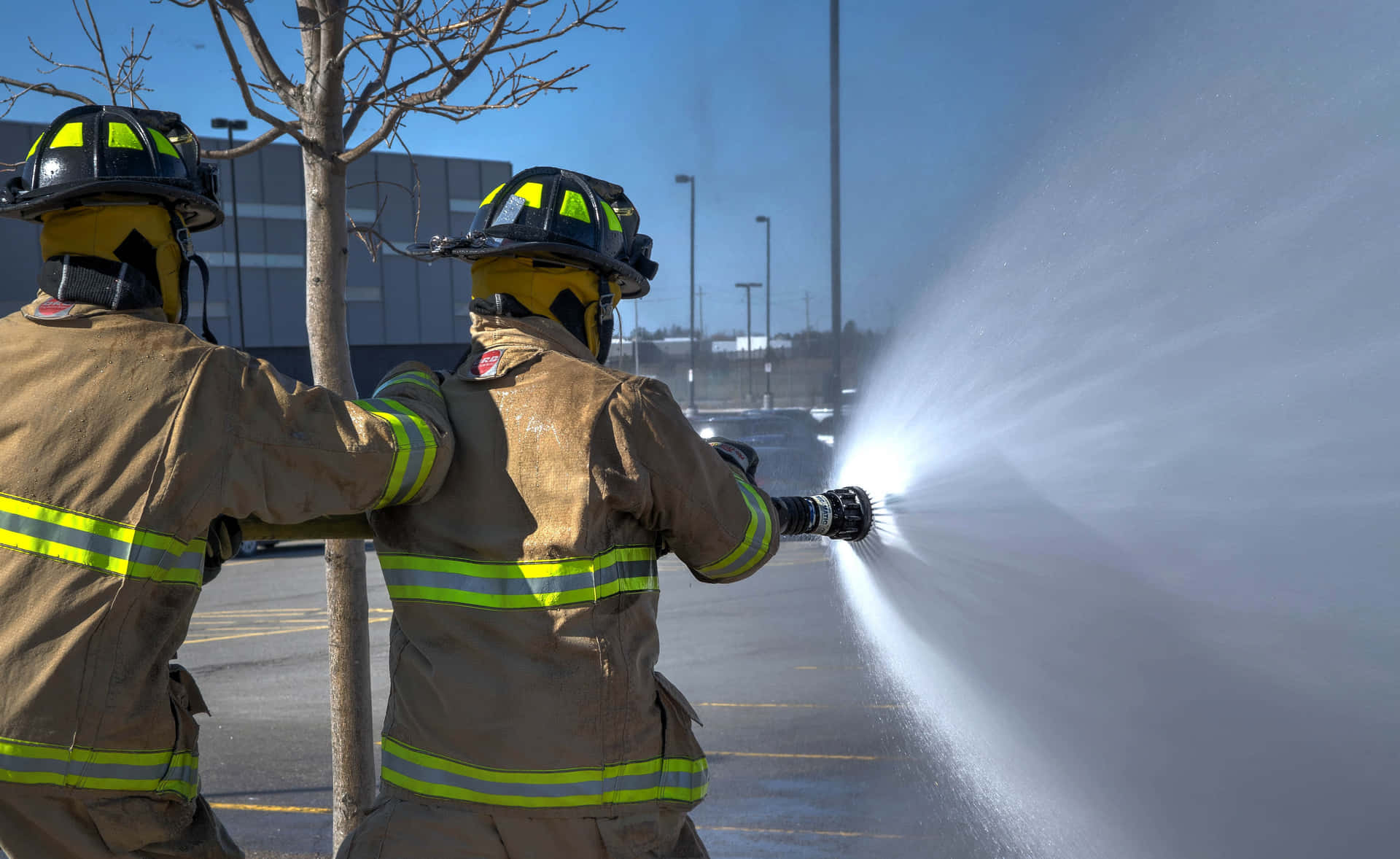 Two Firemen Spraying Water