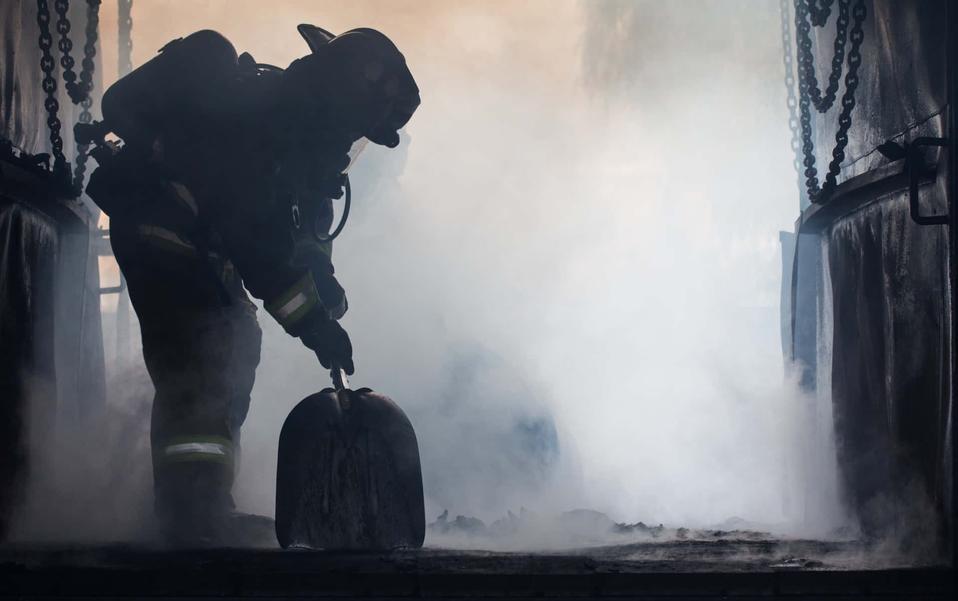 A Firefighter Is Putting Out A Fire