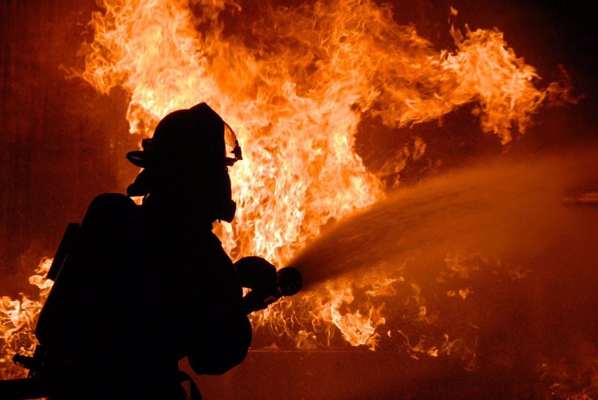 Firefighter Struggling With Strong Fire Wallpaper
