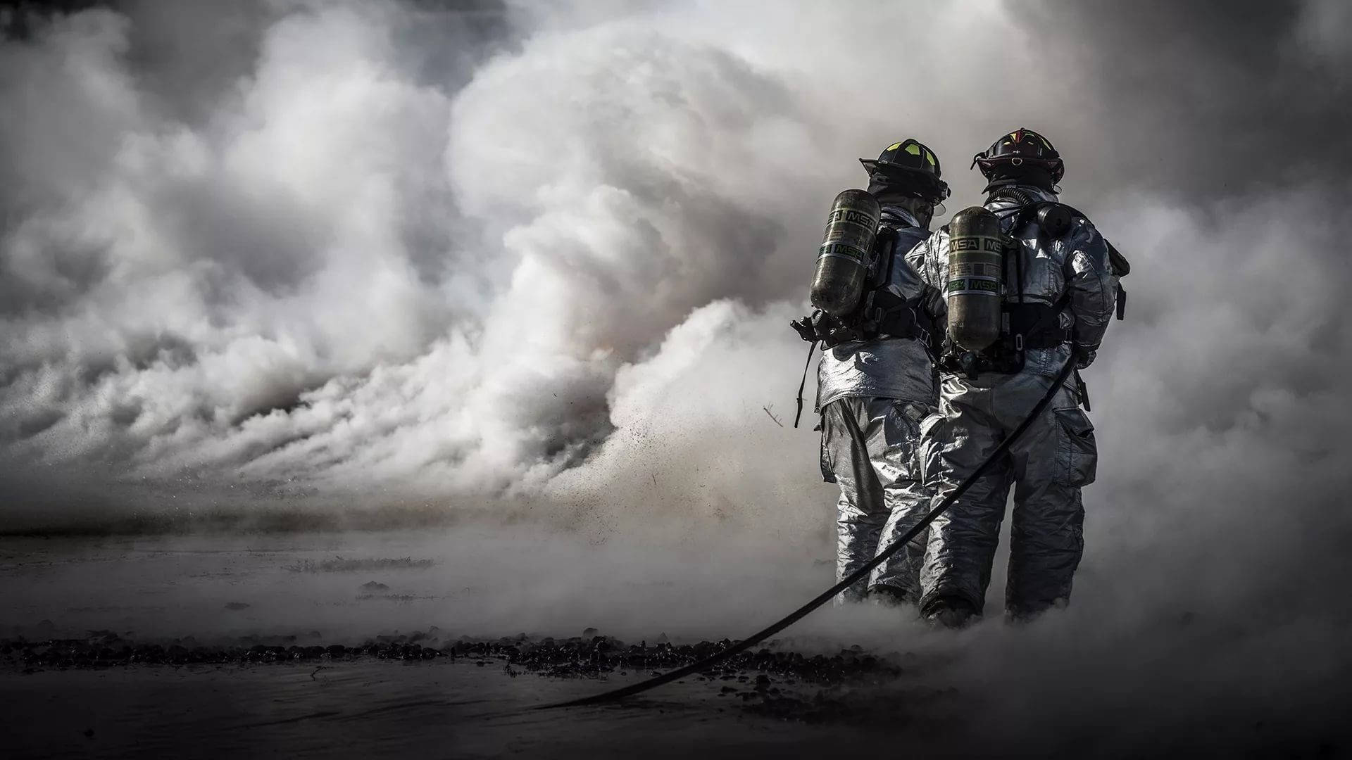 Firefighters In A Smoky Corner Wallpaper