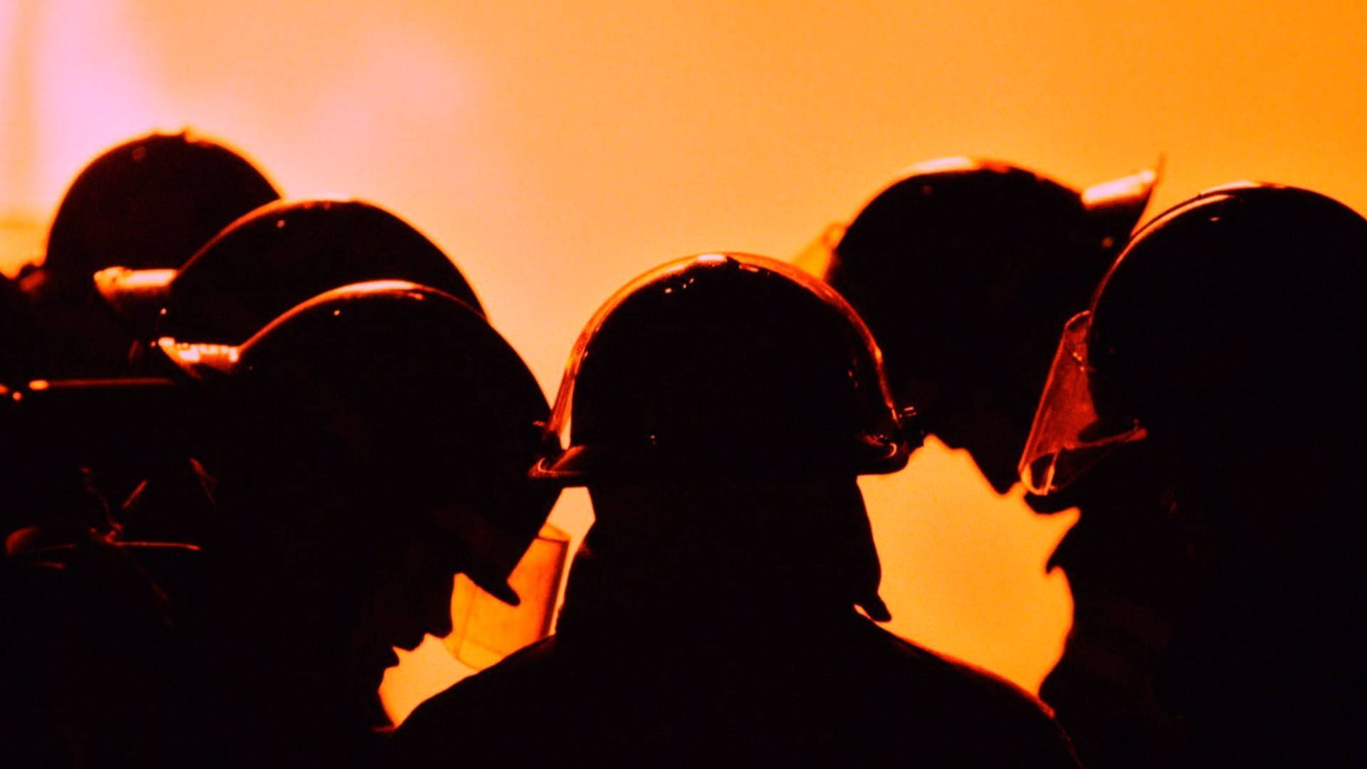 Firefighters On Duty Huddle Silhouette Wallpaper