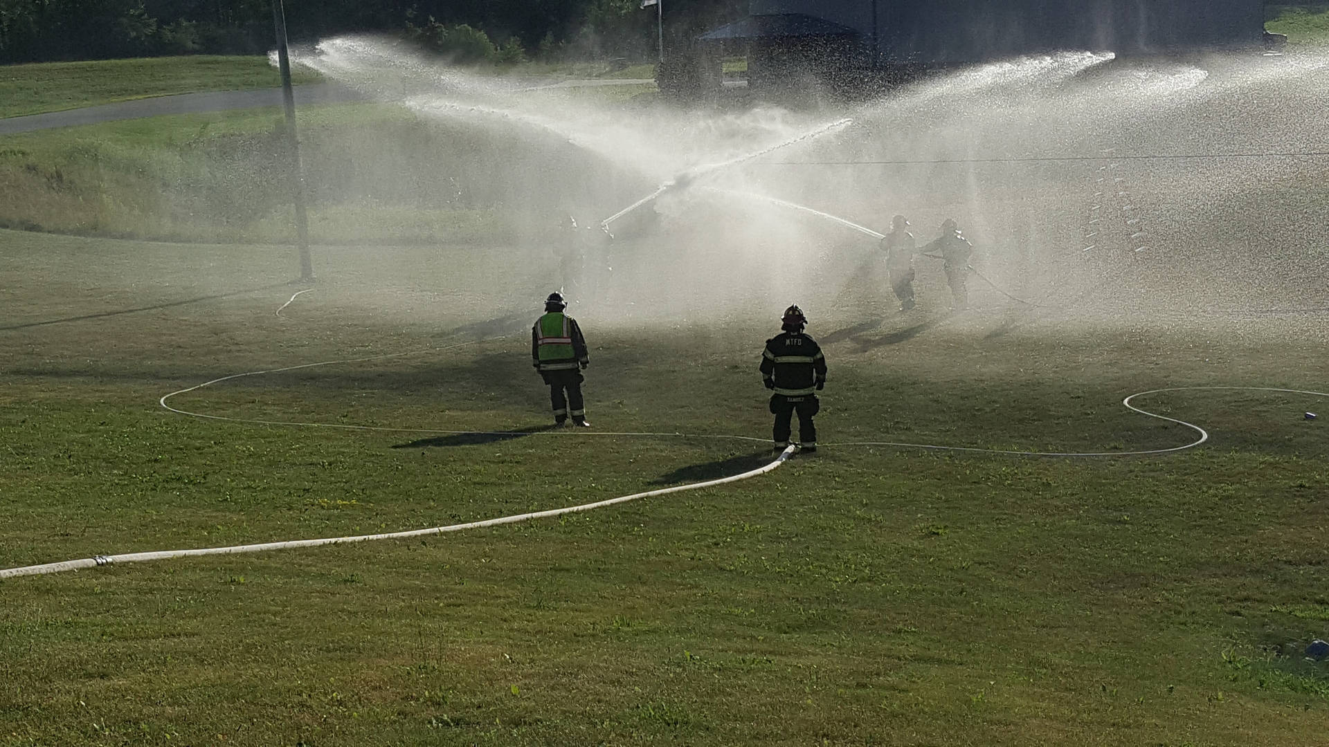 Firefighters Practicing Fire Hoses Wallpaper