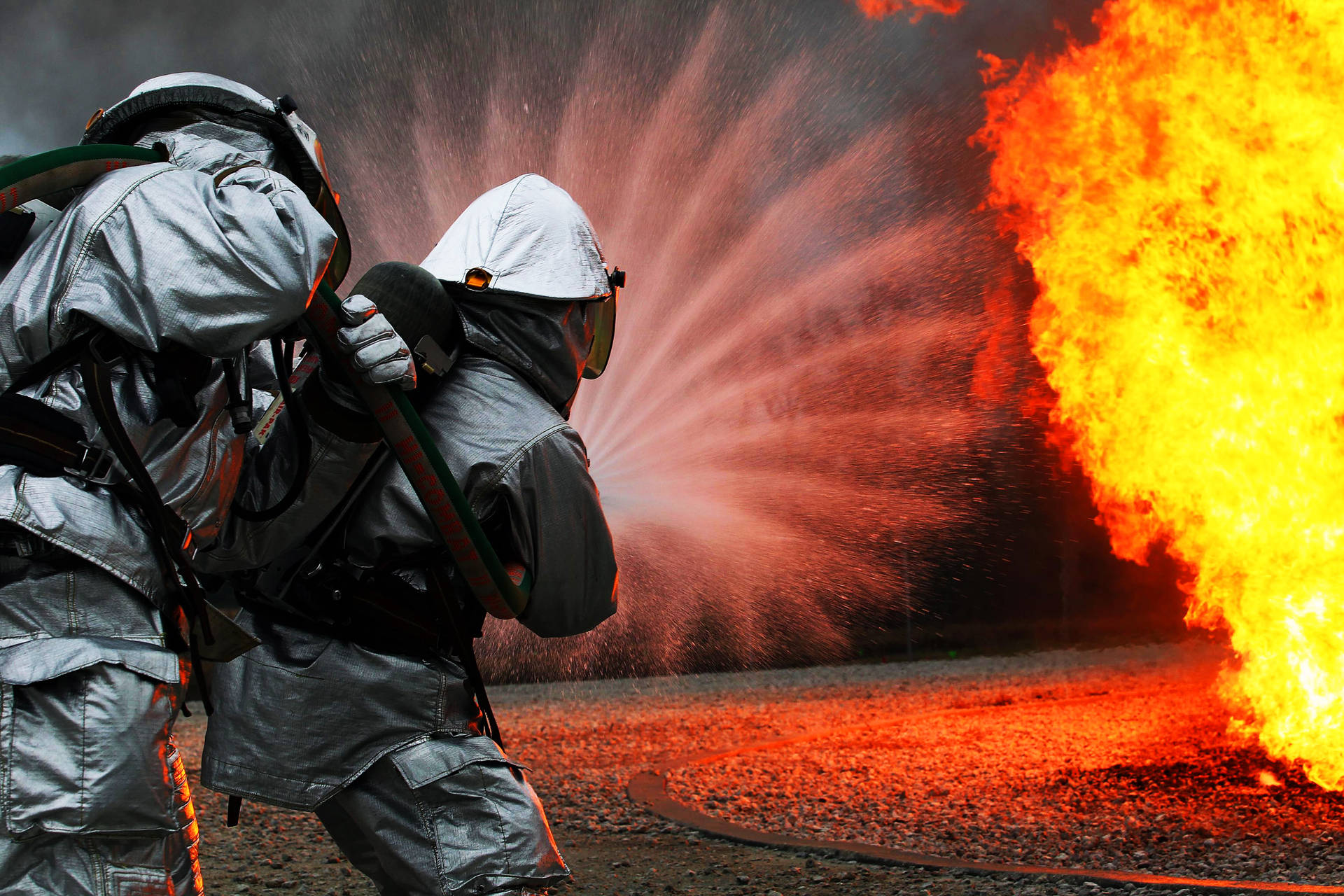 Fireman Behind A Powerful Water Blast Wallpaper