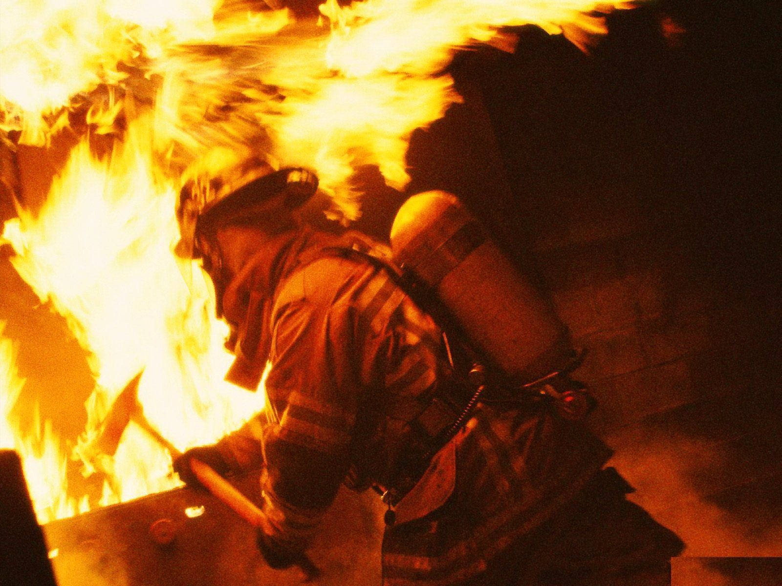 Fireman Inside A Burning Building Wallpaper