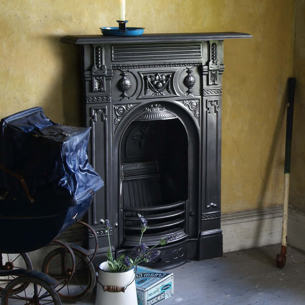 A Fireplace With A Baby Carriage And A Candle