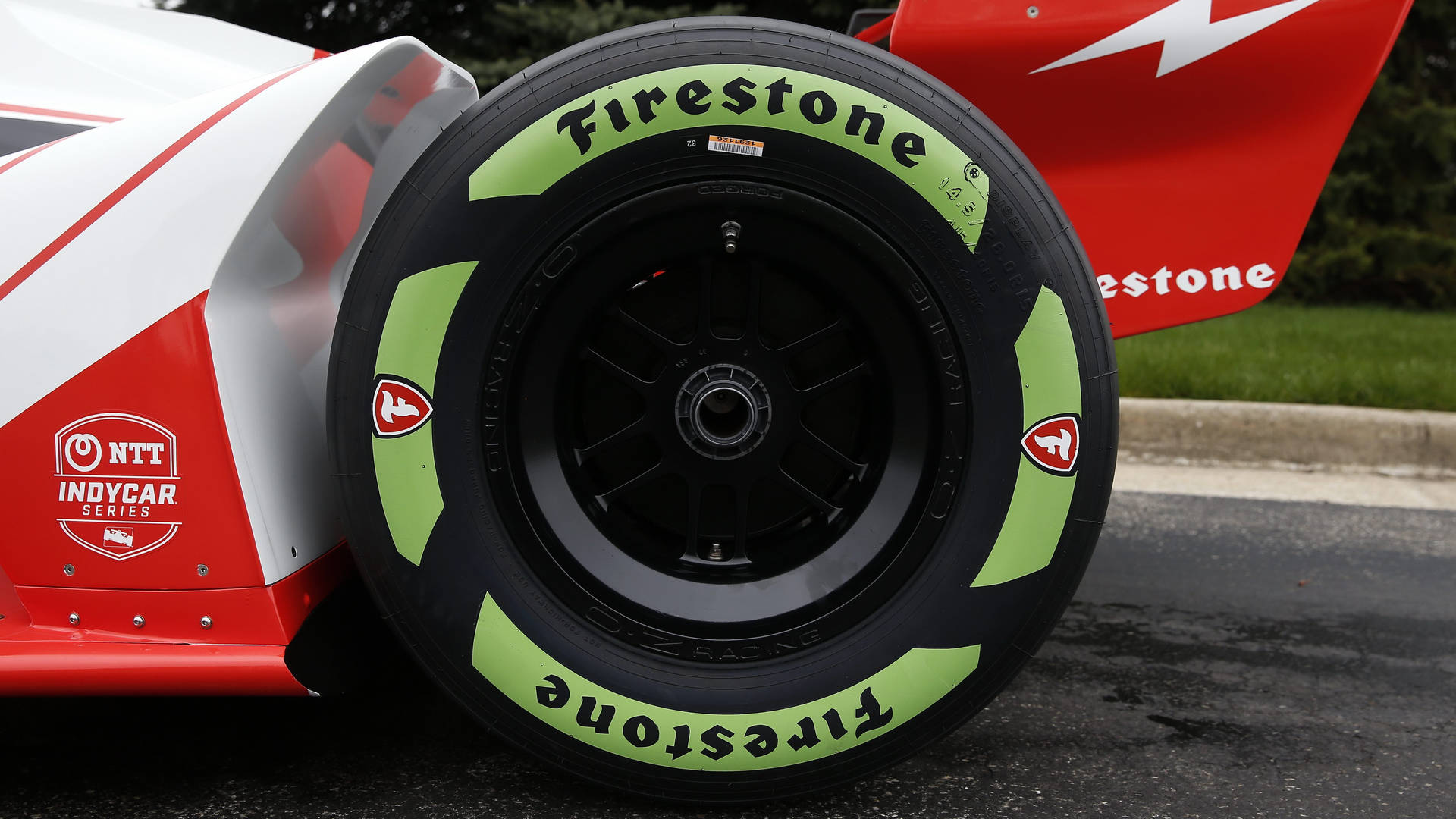 Firestone Black And Green Tire On Racecar Wallpaper