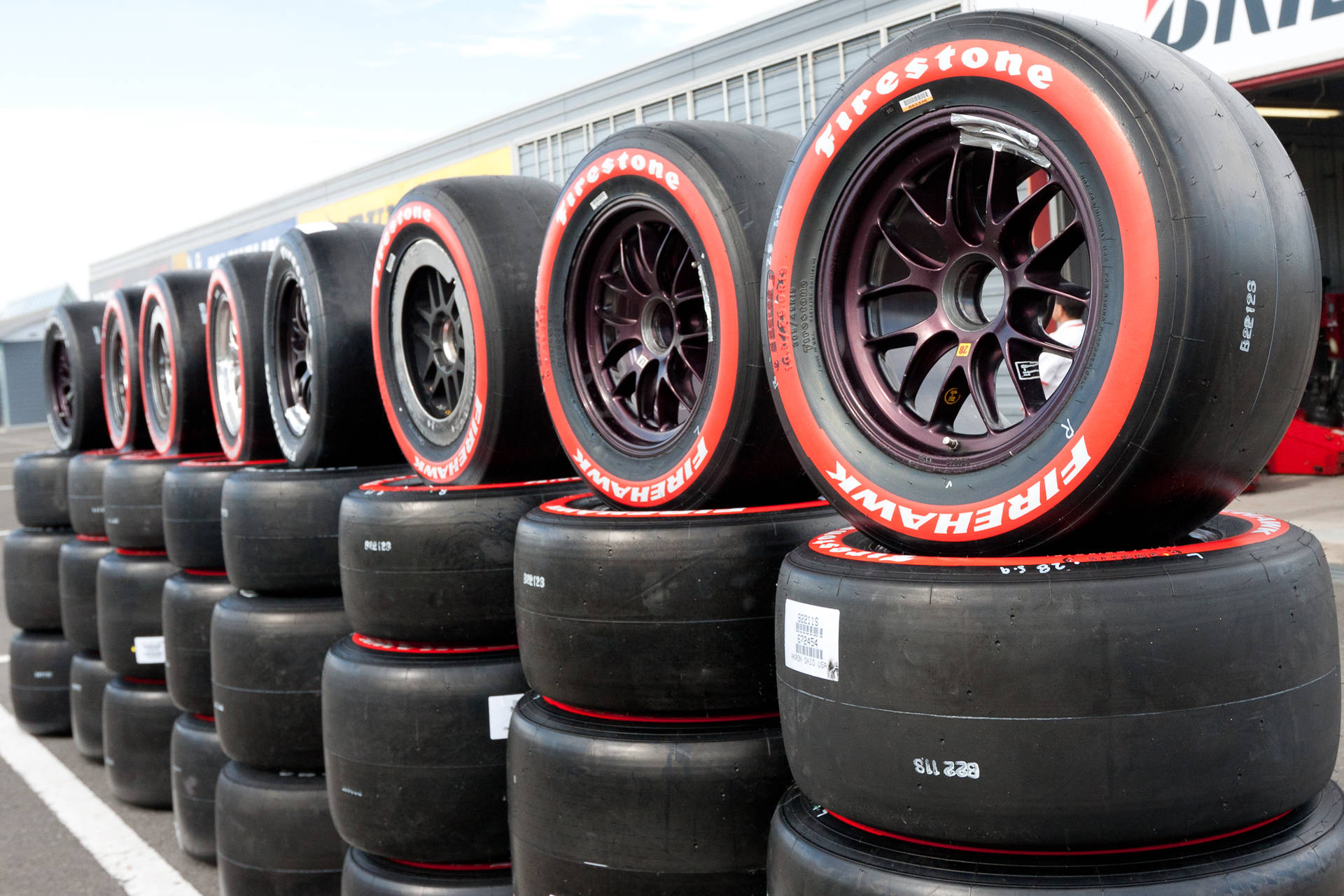 Firestone Black And Red Stacks Of Tires Wallpaper