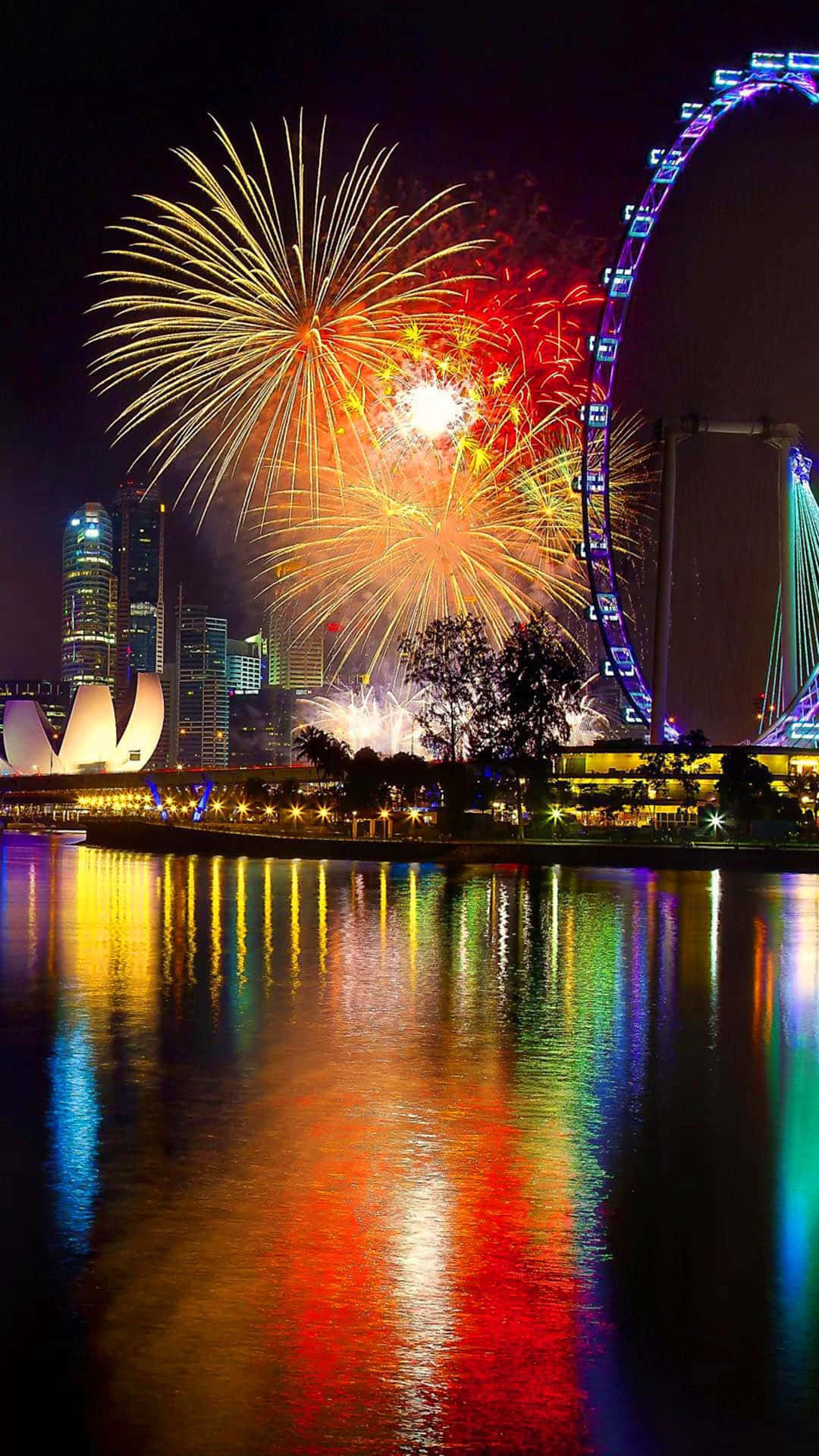 Fireworks Display In City Water Reflection Wallpaper