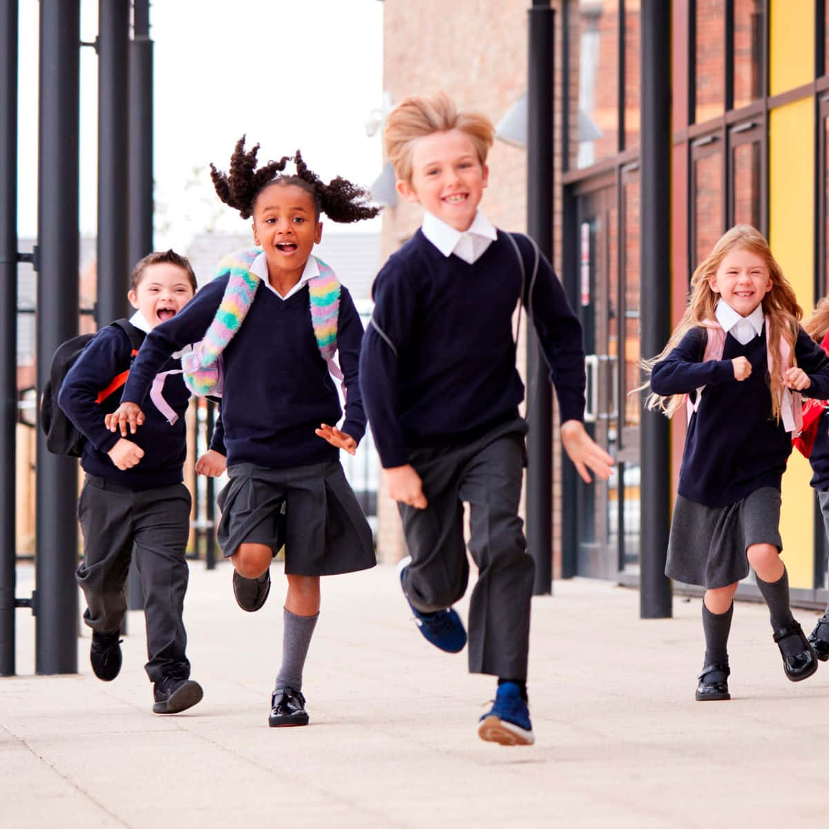 A Group Of Children Running In School Uniforms