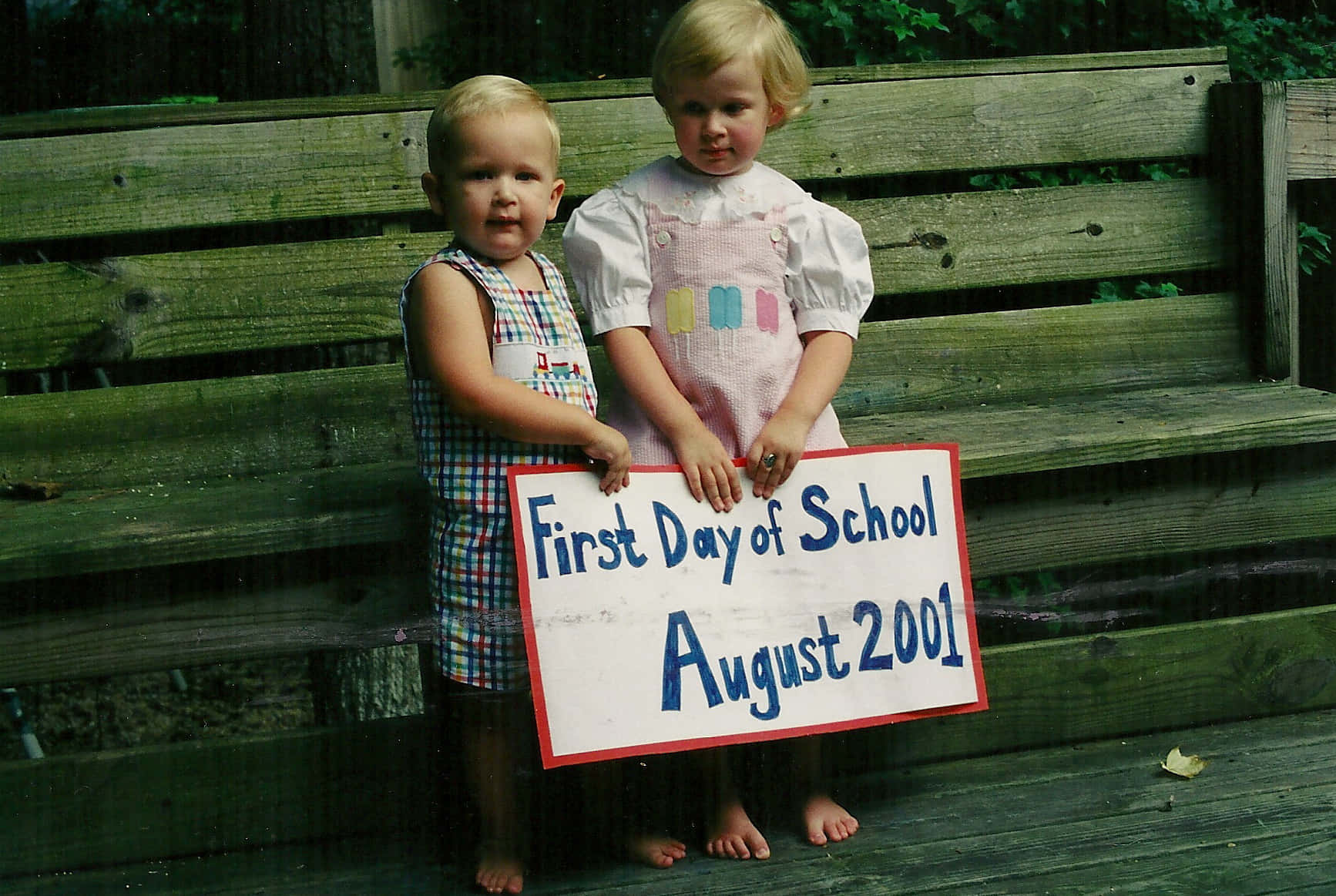 Two Children Holding A Sign