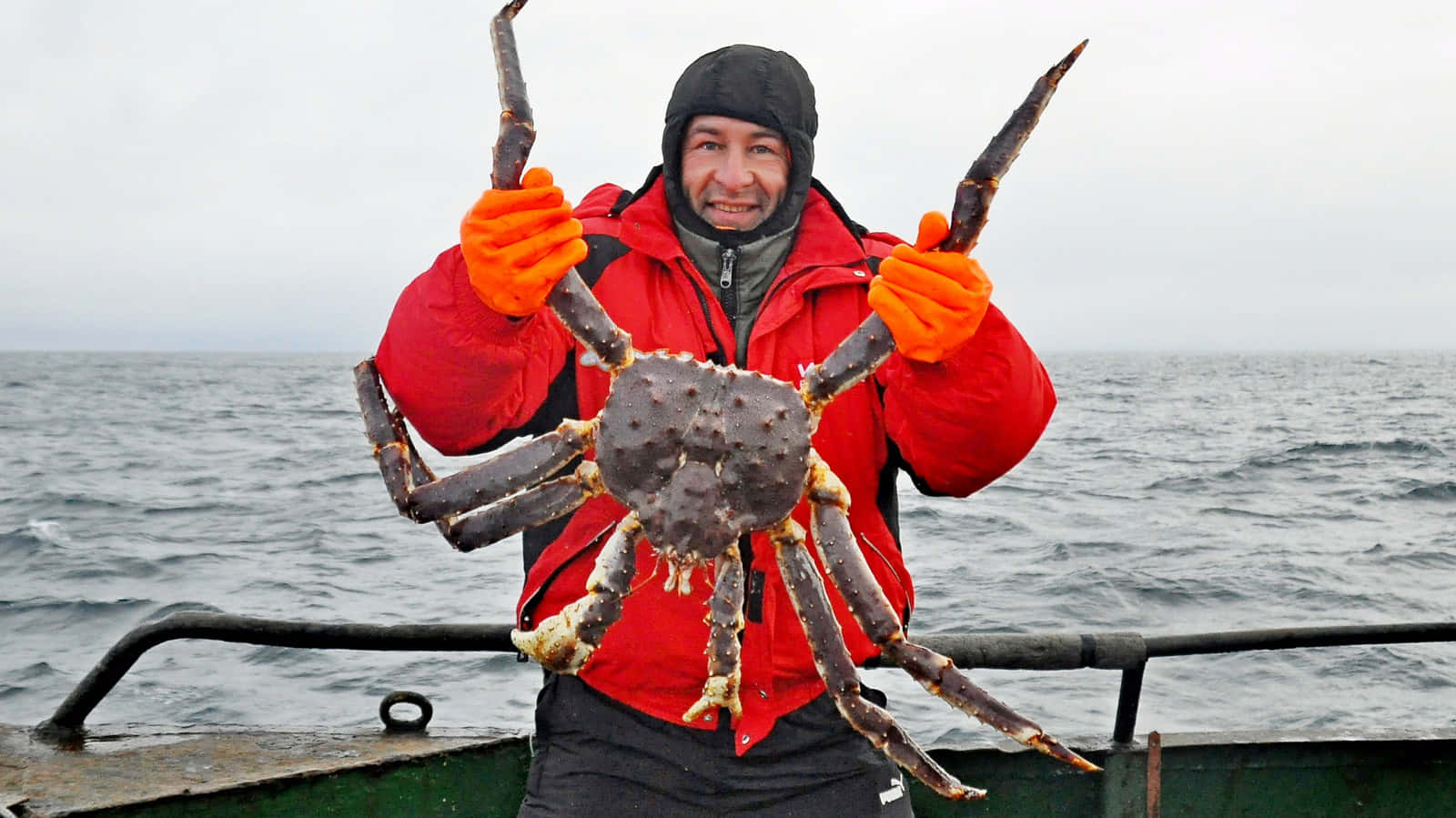 Fisherman Holding Giant Crab Wallpaper