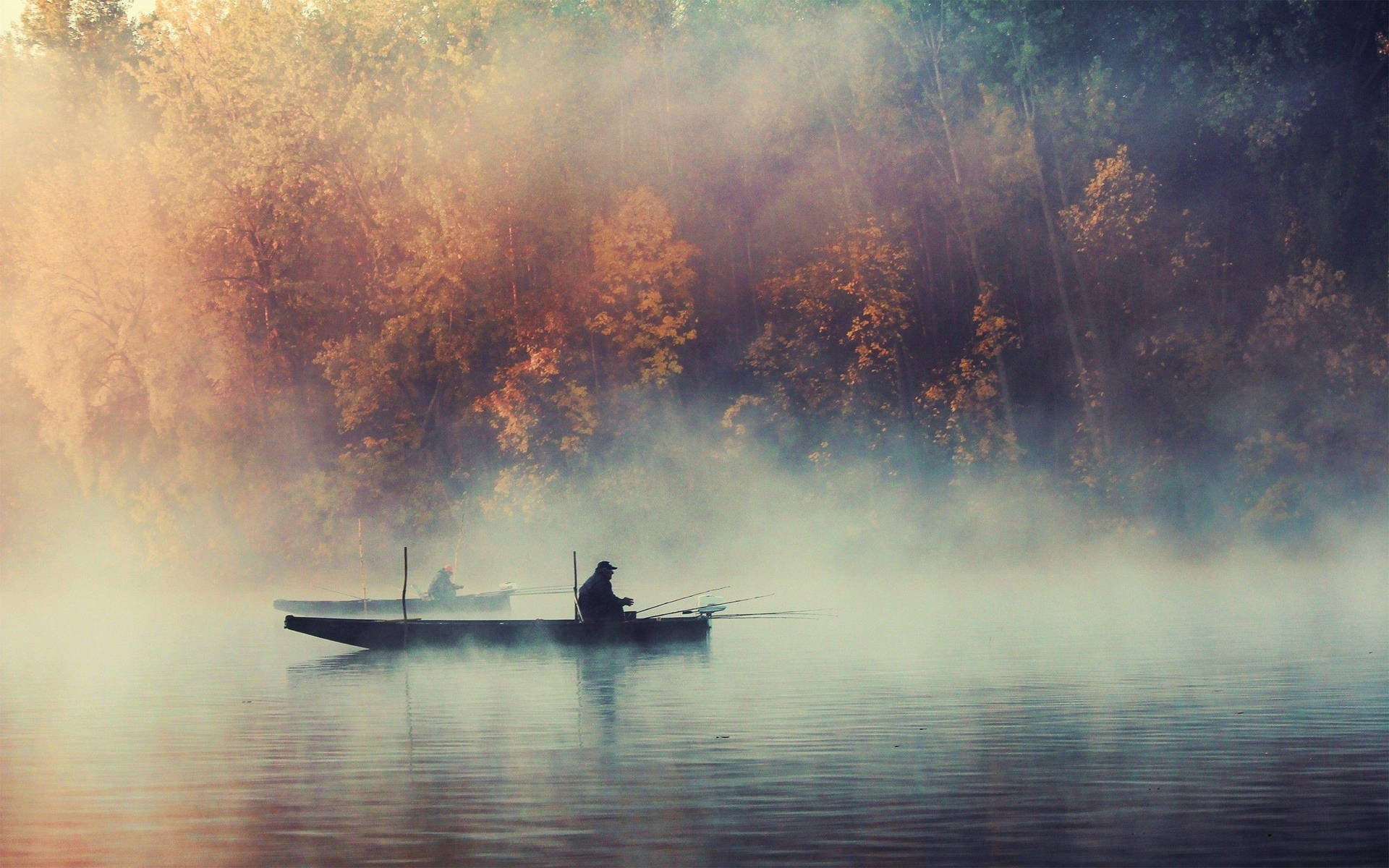 Enjoying an Early Morning Fishing Trip in a Misty Lake Wallpaper