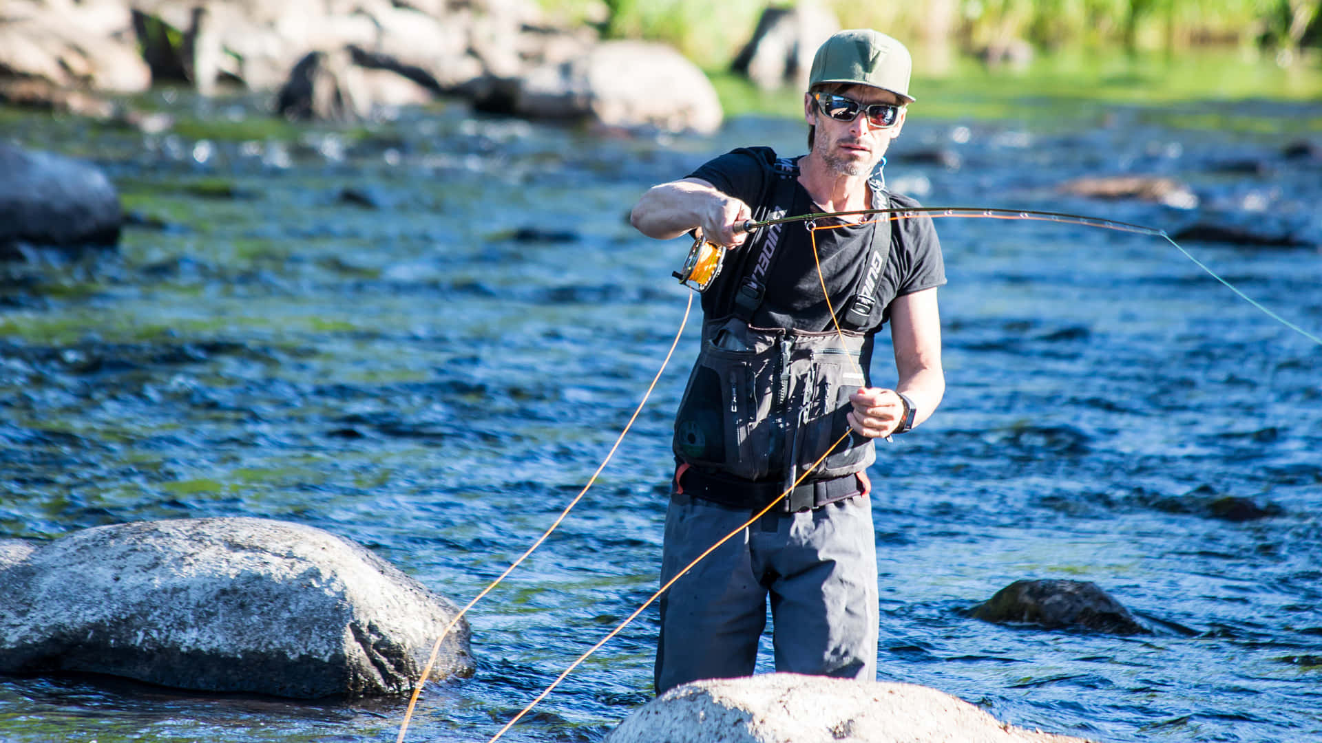 Angler holding fishing rod against beautiful lake backdrop Wallpaper