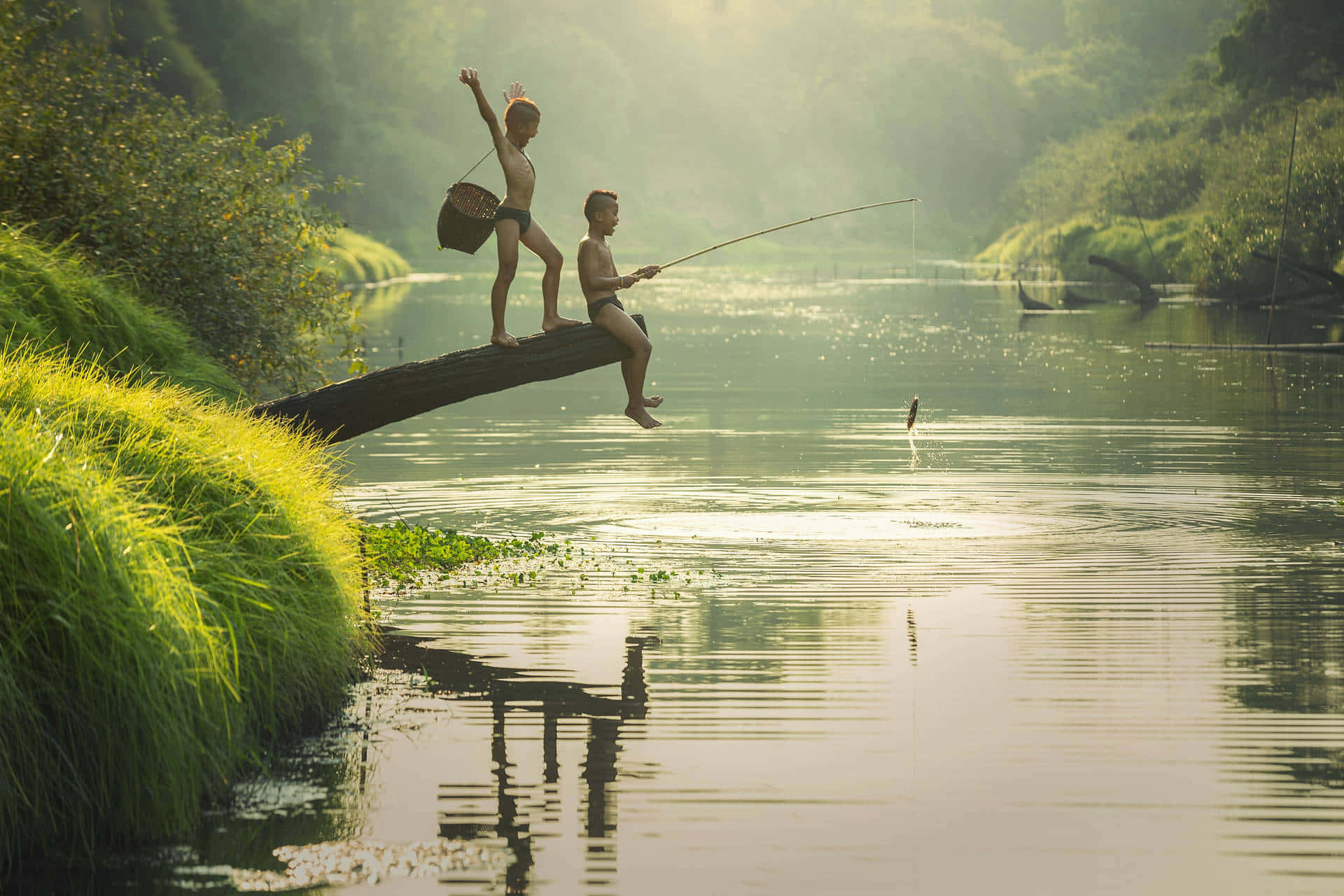 Angler fishing with a sturdy rod on a stunningly beautiful day Wallpaper