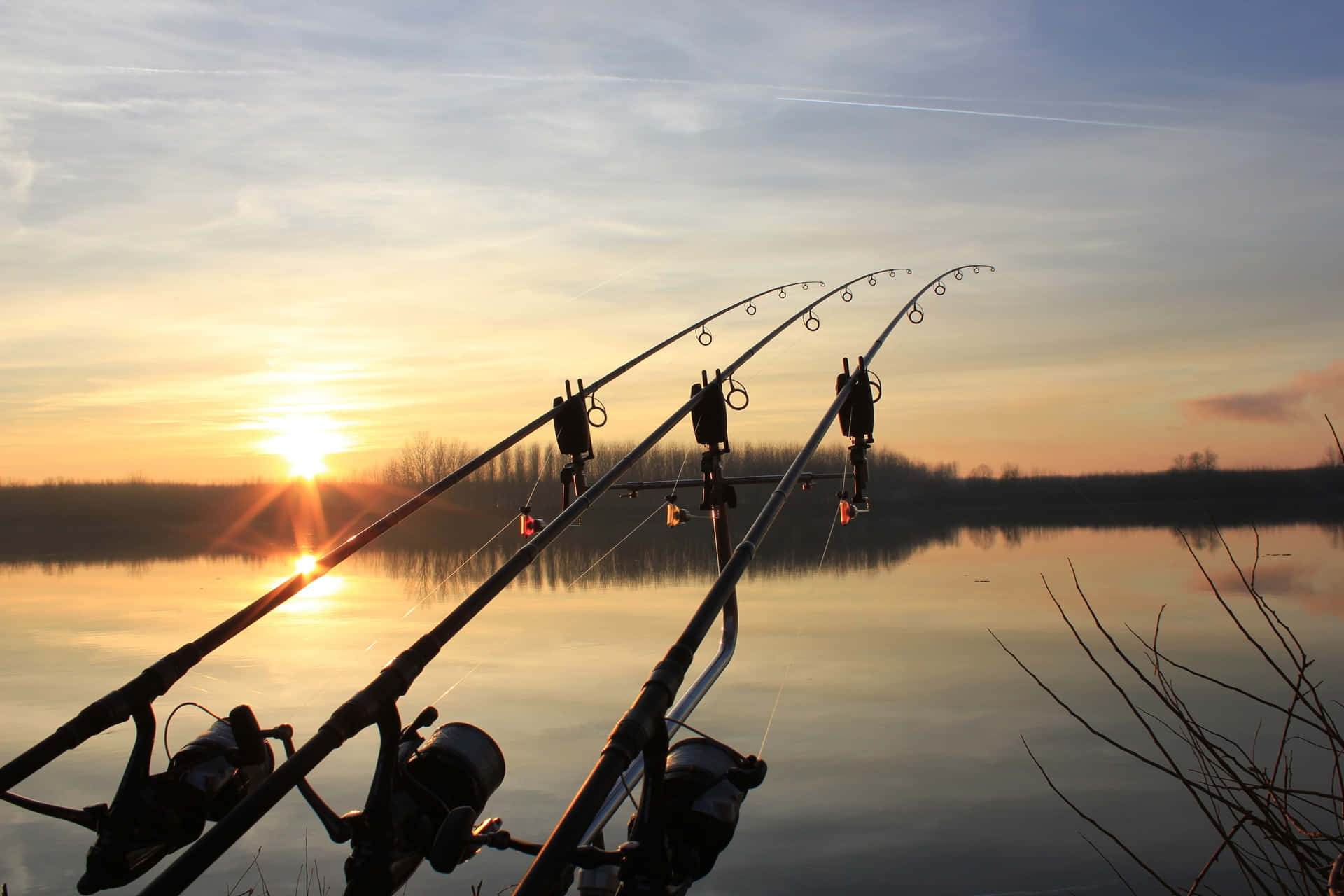 Angler Holding a Fishing Rod Beside a Beautiful Lake Wallpaper