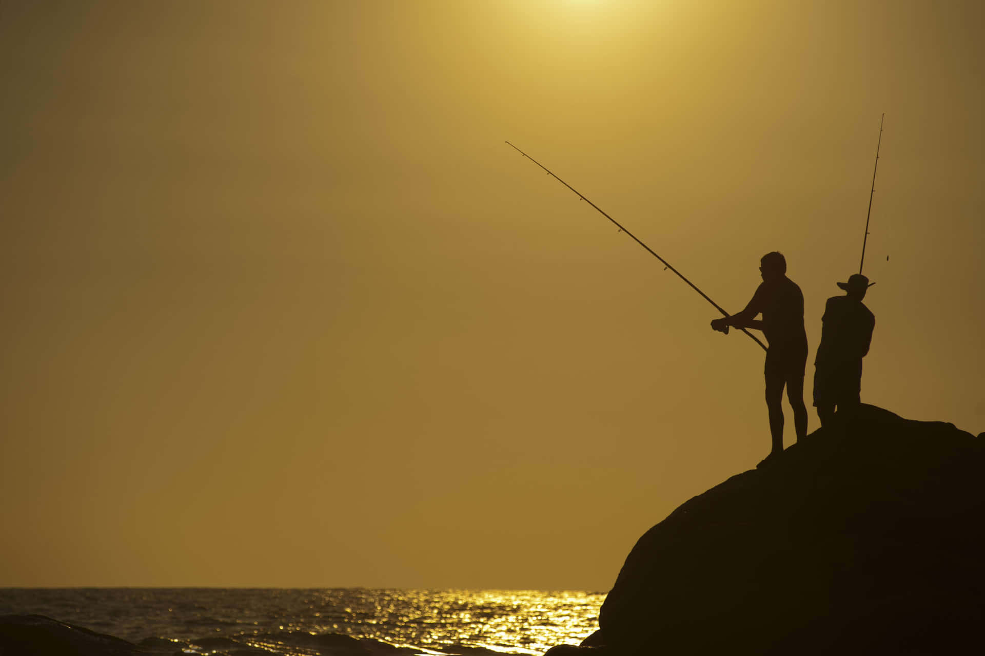 Fishing Enthusiast holding a Fishing Rod near the Lake Wallpaper