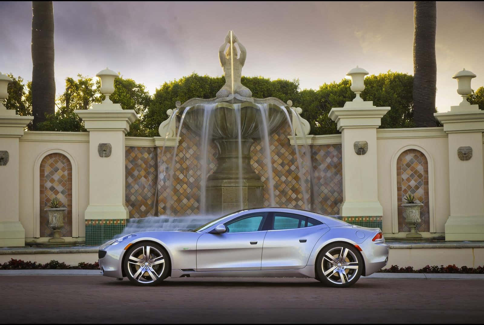 Sleek Fisker electric vehicle on a vibrant city street Wallpaper