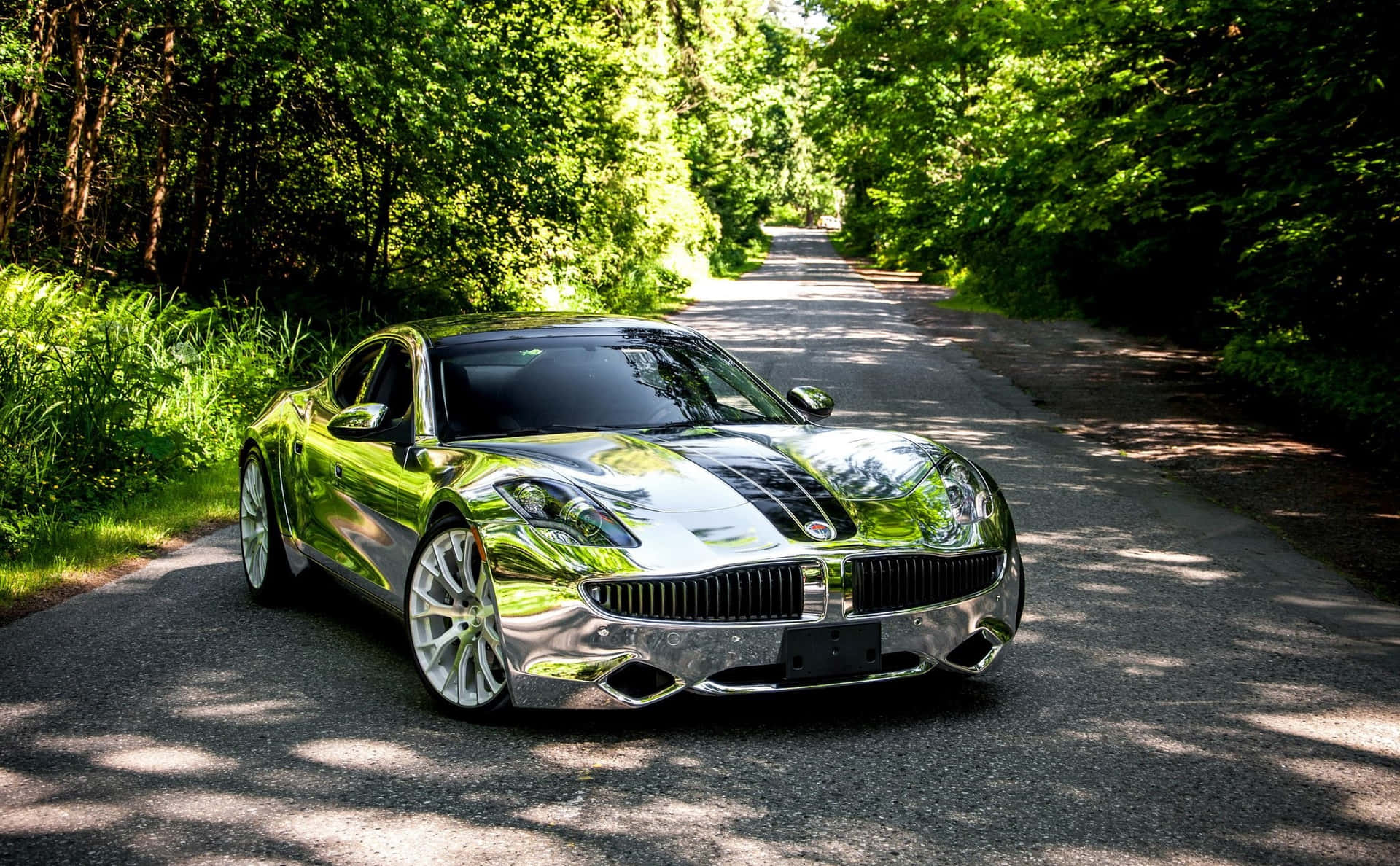 Striking Fisker electric vehicle on a scenic road Wallpaper