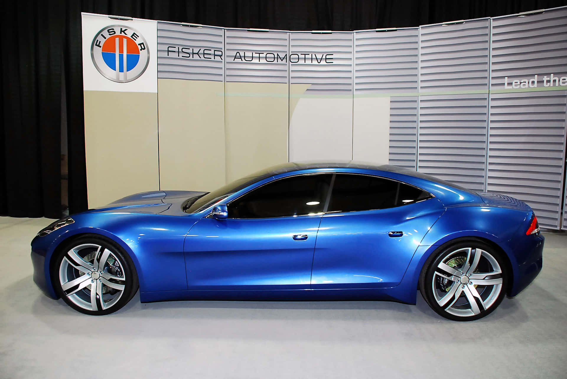 Fisker Karma electric vehicle cruising on open road Wallpaper