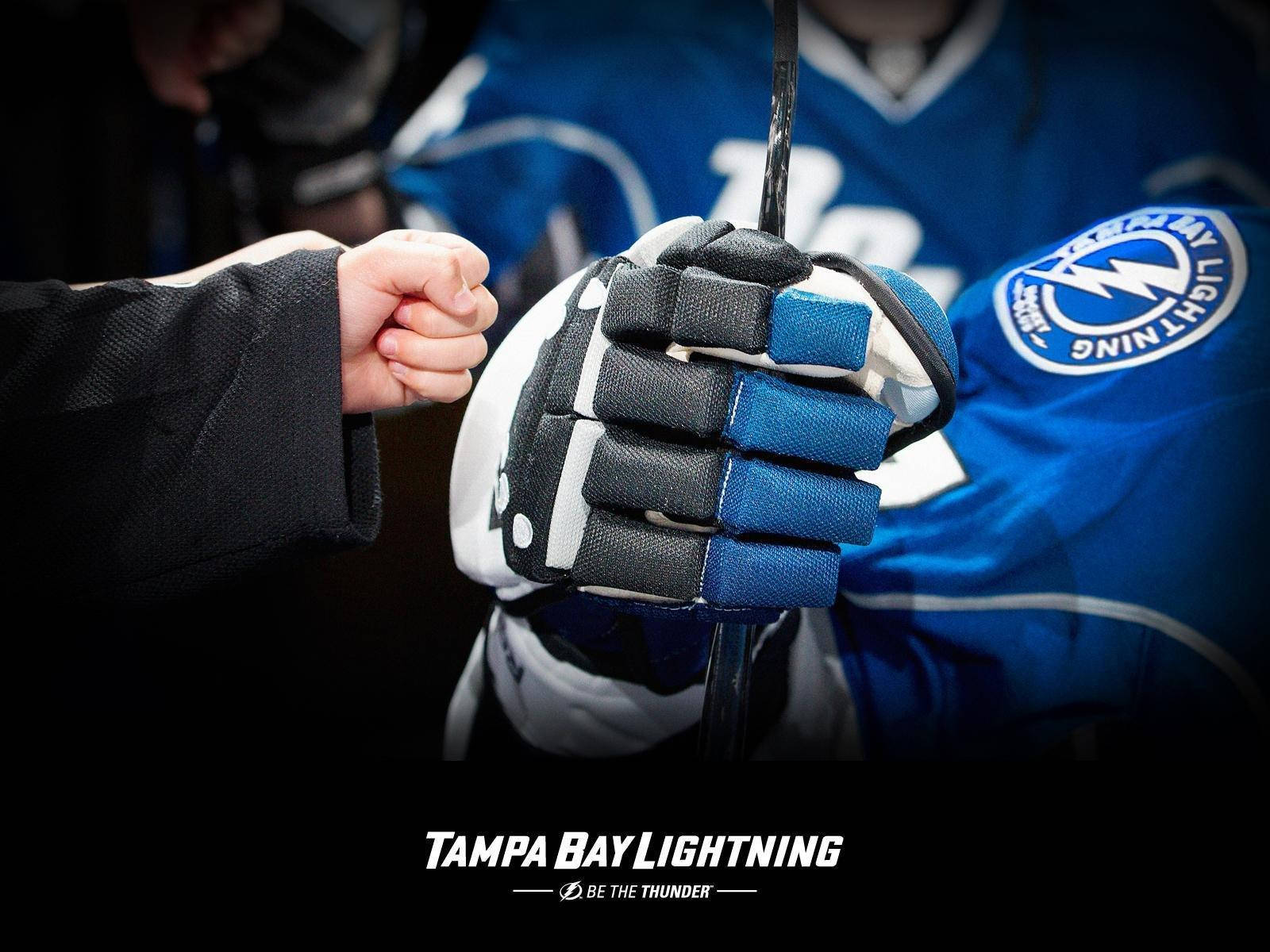 High-energy Fist Bump at Tampa Bay Lightning Game Wallpaper