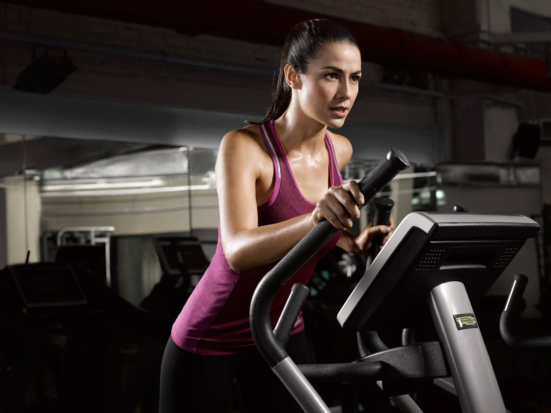 Fit Woman Running On Treadmill Wallpaper