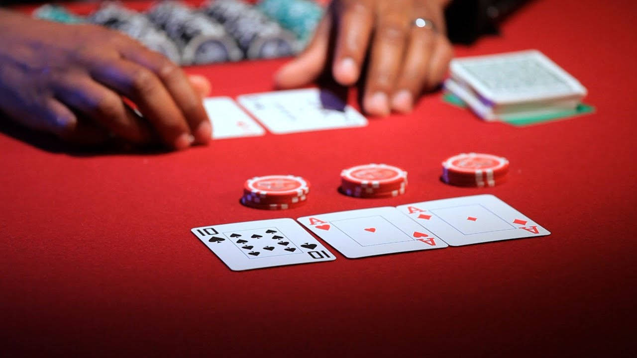 A Five-Card Draw Game in Action with Red Poker Chips Wallpaper