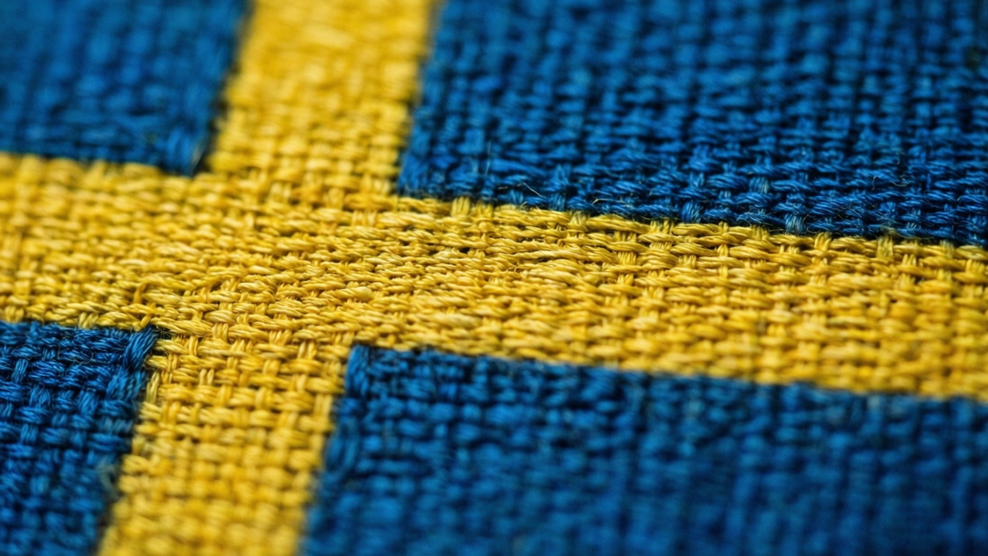 Lähikuva makrokuva Ruotsin lippukankaan kudotusta tekstuurista.