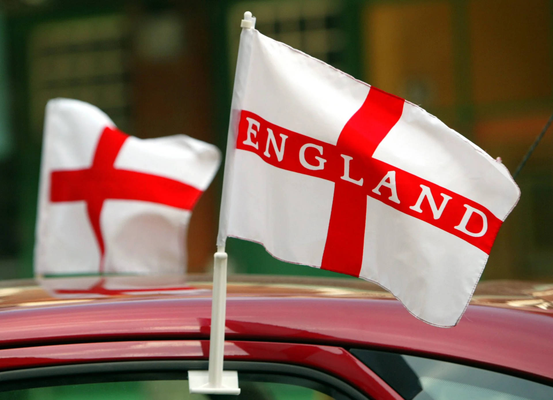 Engaging display of the England flag fluttering against the clear sky Wallpaper