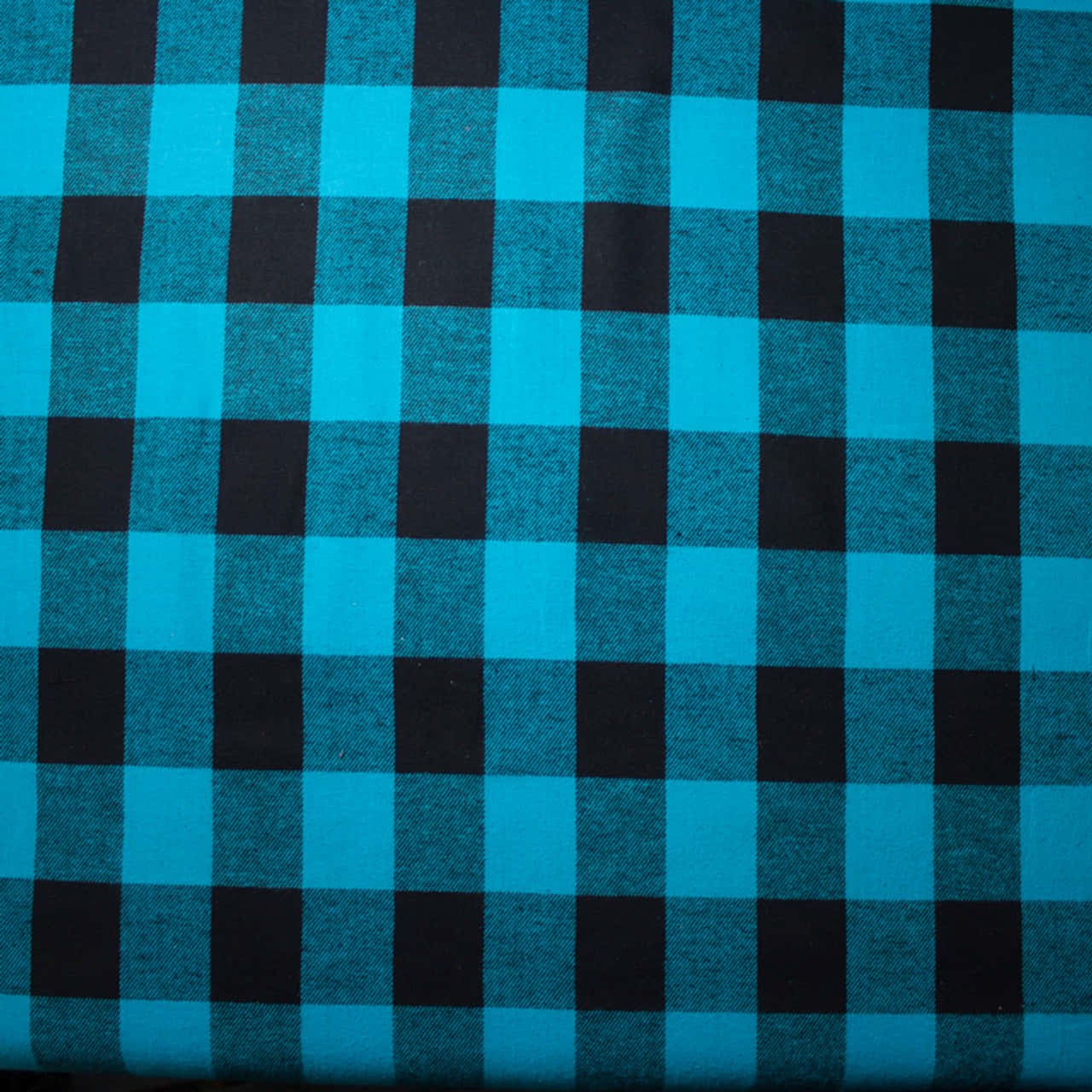 a close up of a blue and black checkered fabric