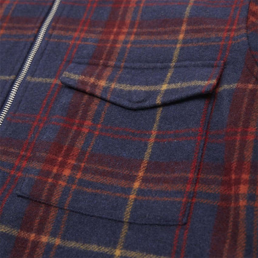 a close up of a plaid jacket with pockets