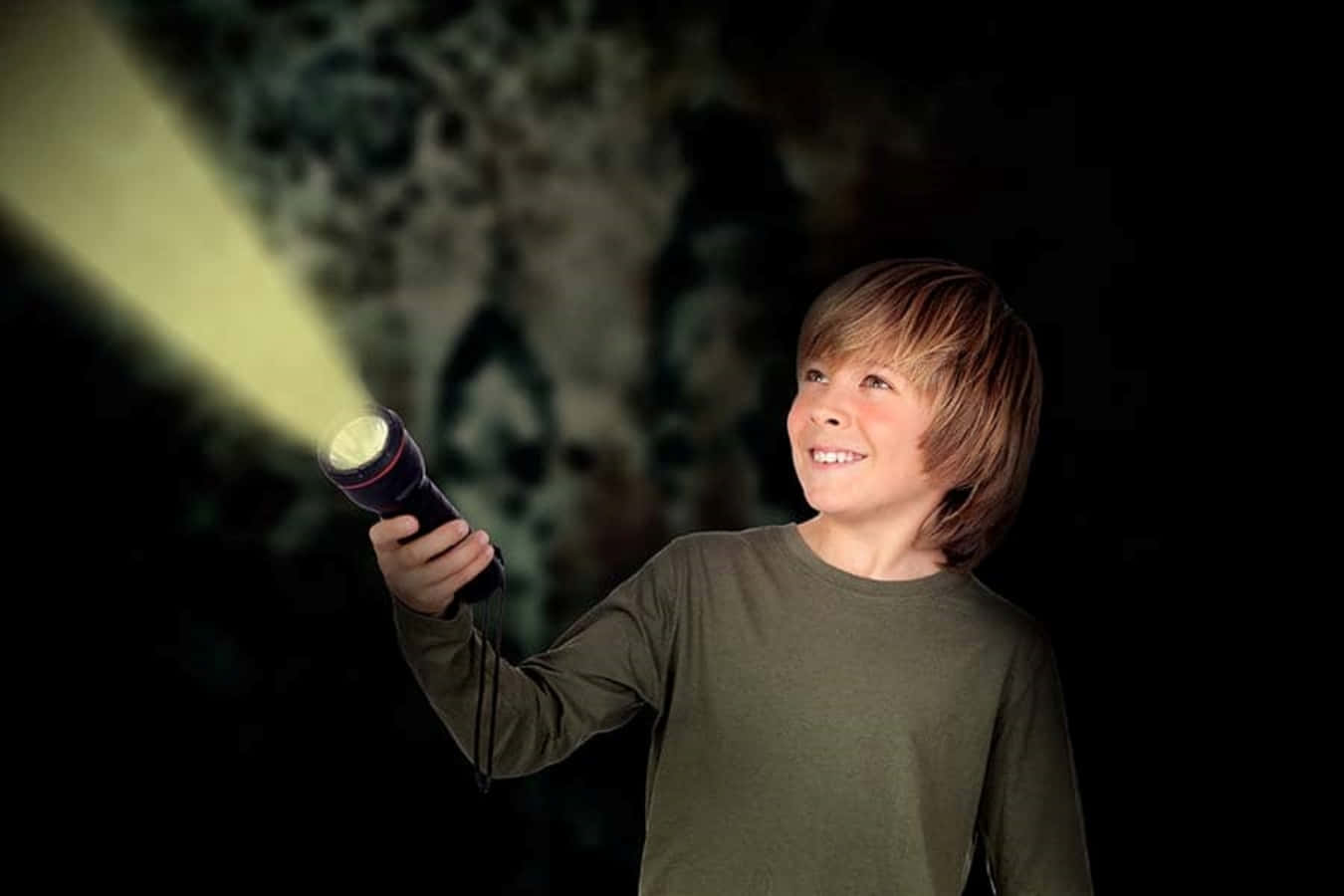 A Boy Holding A Flashlight