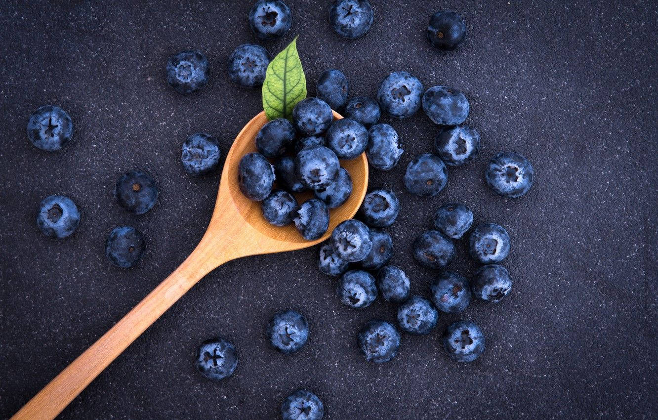 Flat Lay Of Blueberries On A Spoon Wallpaper