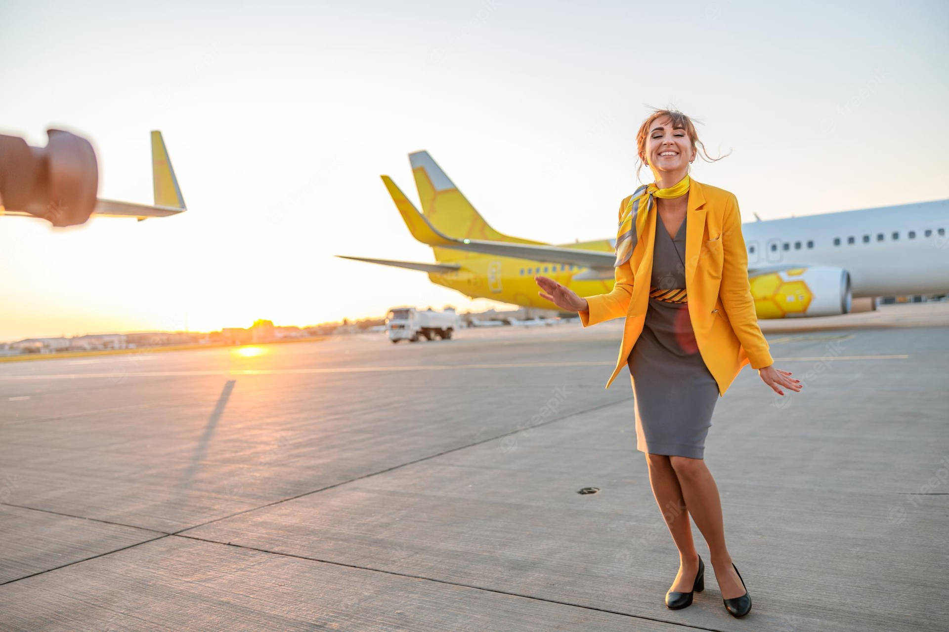 Download Flight Attendant In Yellow Wallpaper 