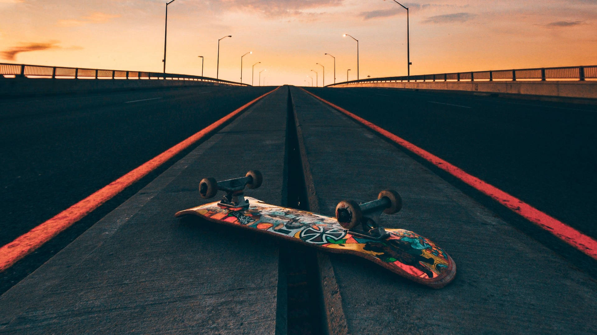 Flipped Skateboard On Road At Sunset Skater Aesthetic Wallpaper