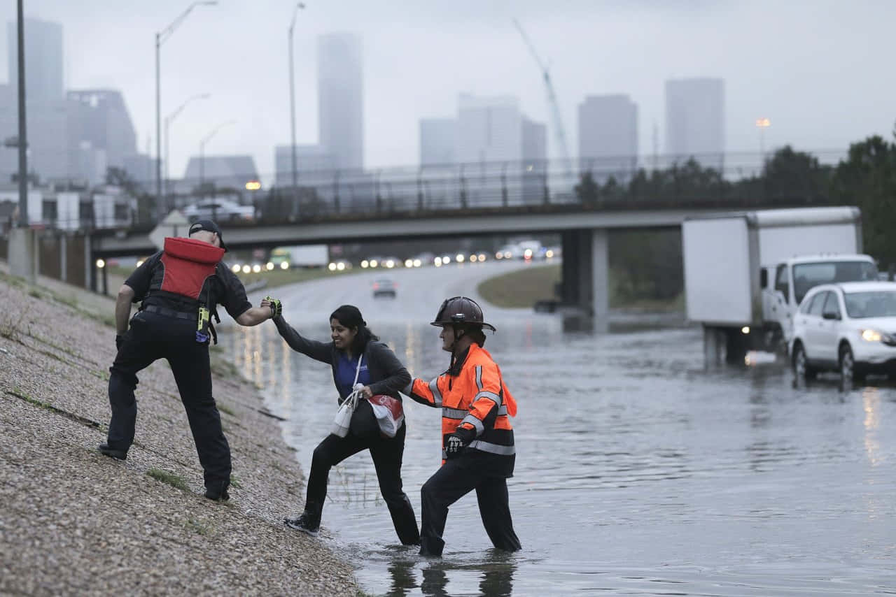 Two People Are Standing In A Flooded Area
