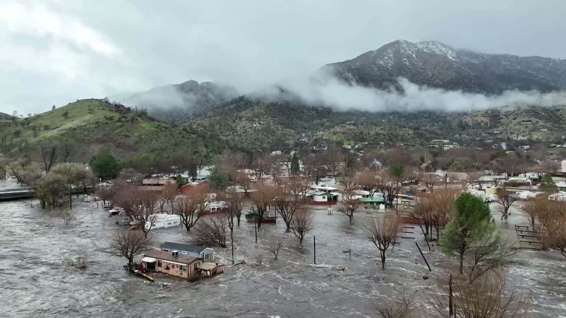 A Town Is Flooded With Water In The Middle Of Mountains