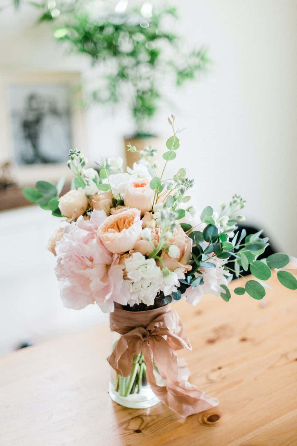 Caption: Elegant Floral Arrangement in a Vase Wallpaper
