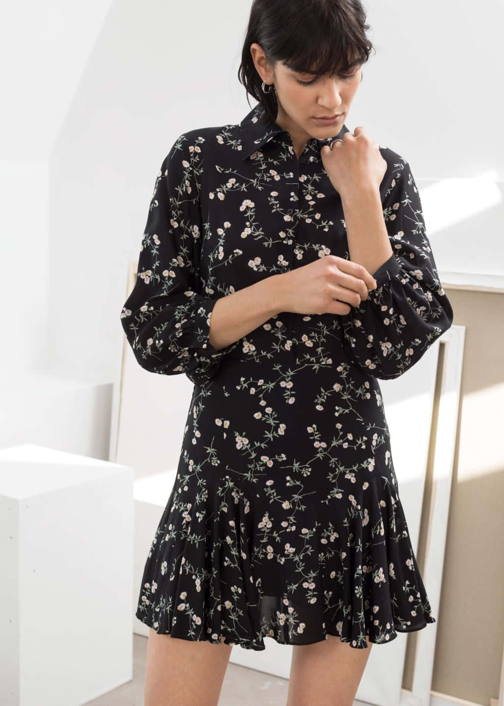 A Woman Wearing A Black Floral Print Dress
