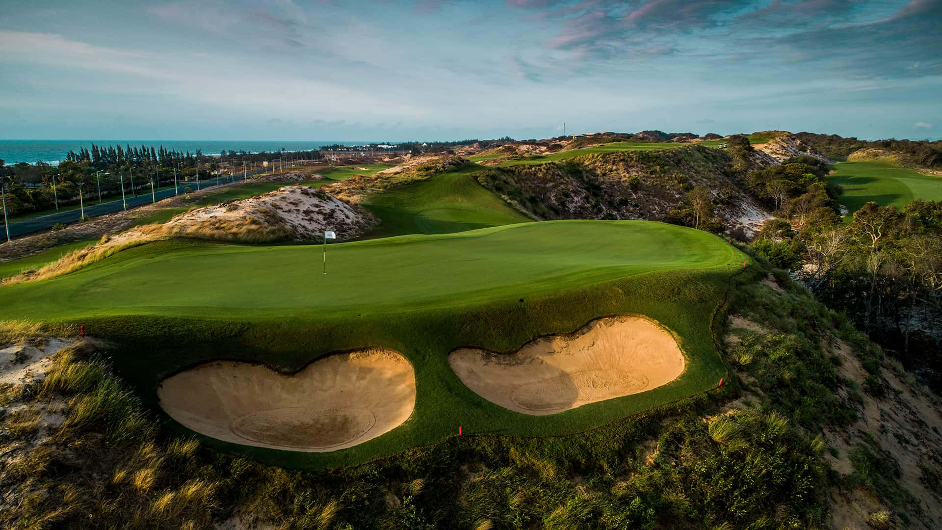 A Golf Course With Two Holes In The Sand Wallpaper