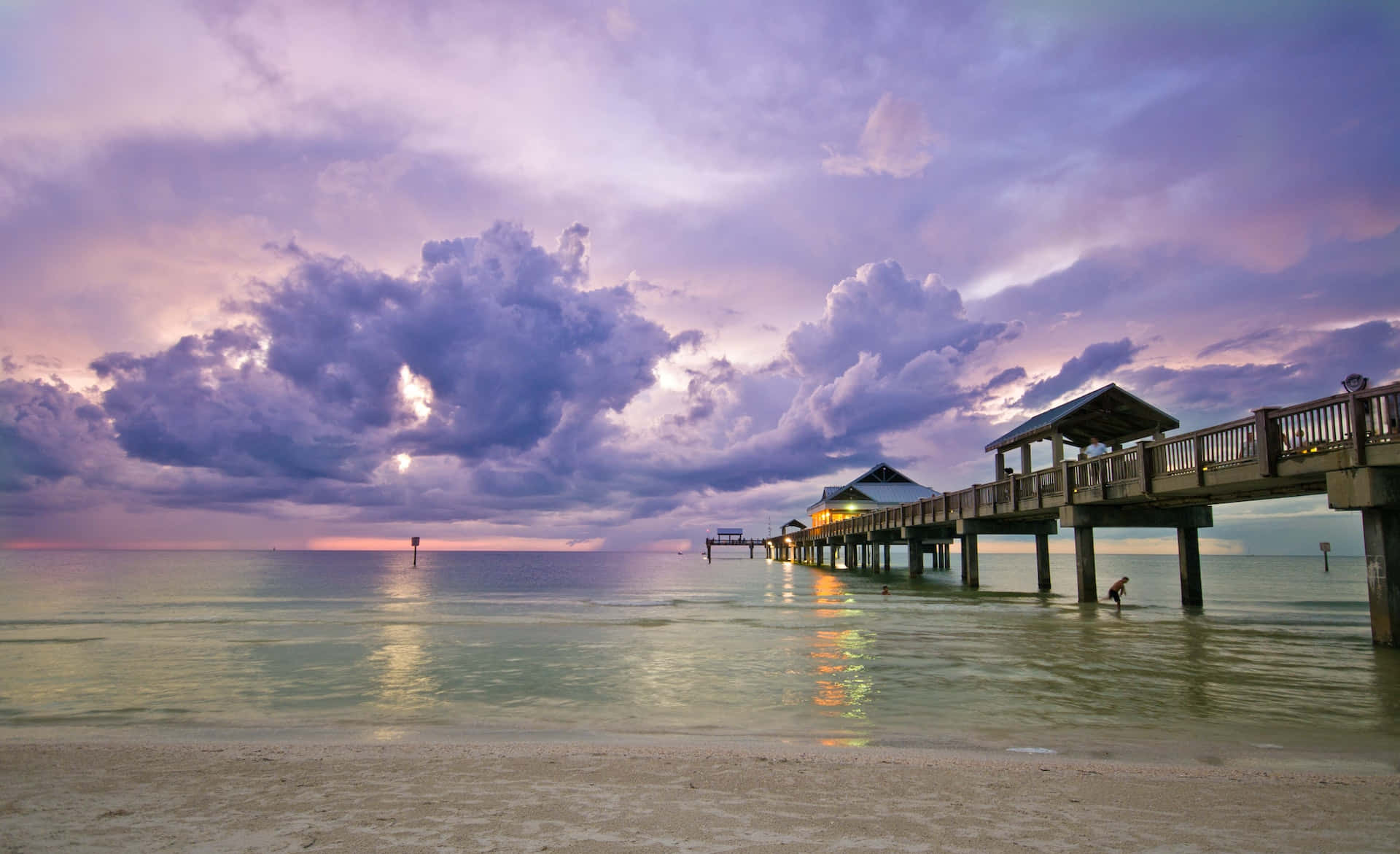 A Pier With A Purple Sky And Clouds