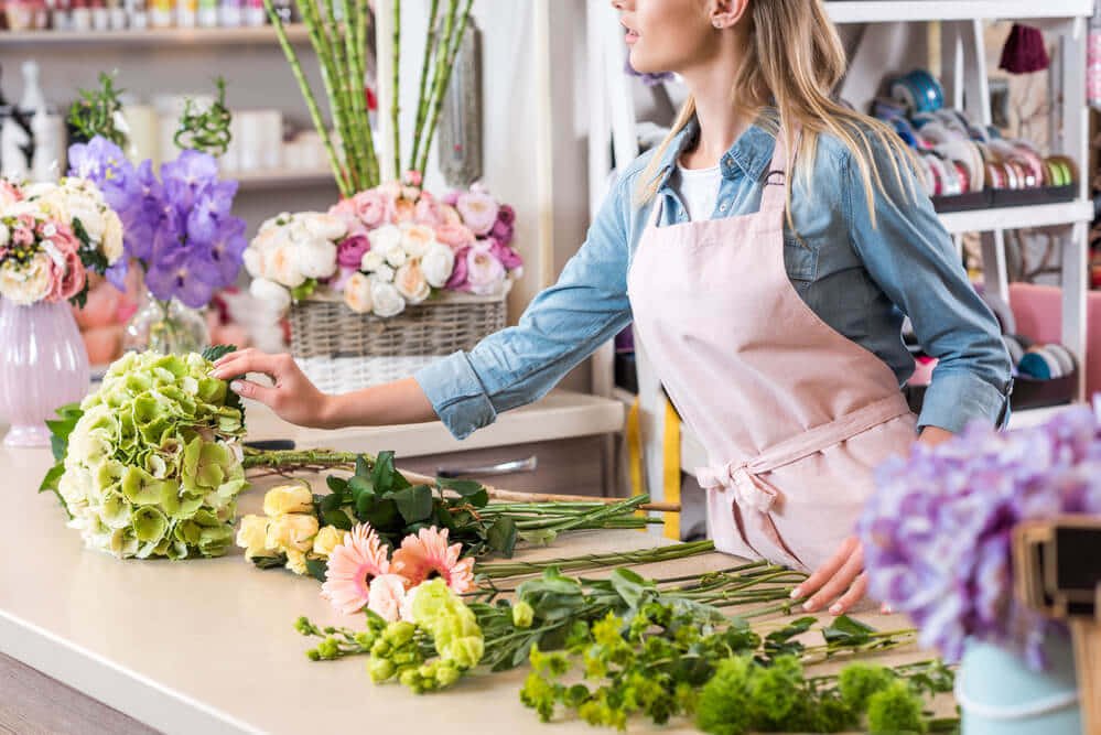 An Expert Florist Crafting A Unique Bouquet of Freshly Picked Flowers Wallpaper
