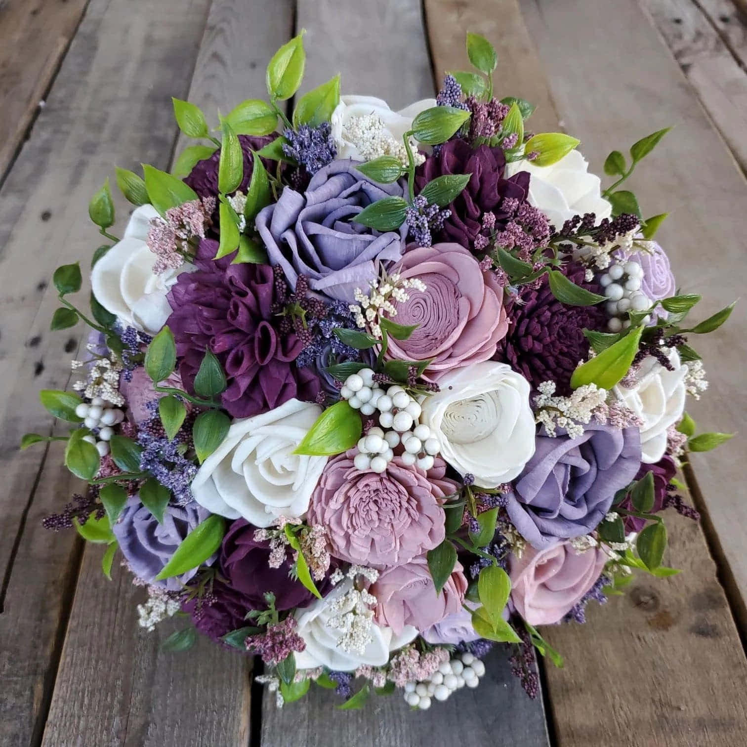 A Bouquet Of Purple And White Flowers On A Wooden Table