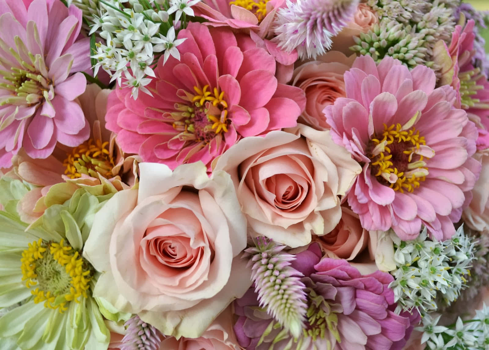 A Bouquet Of Flowers With Pink, Green And White Flowers