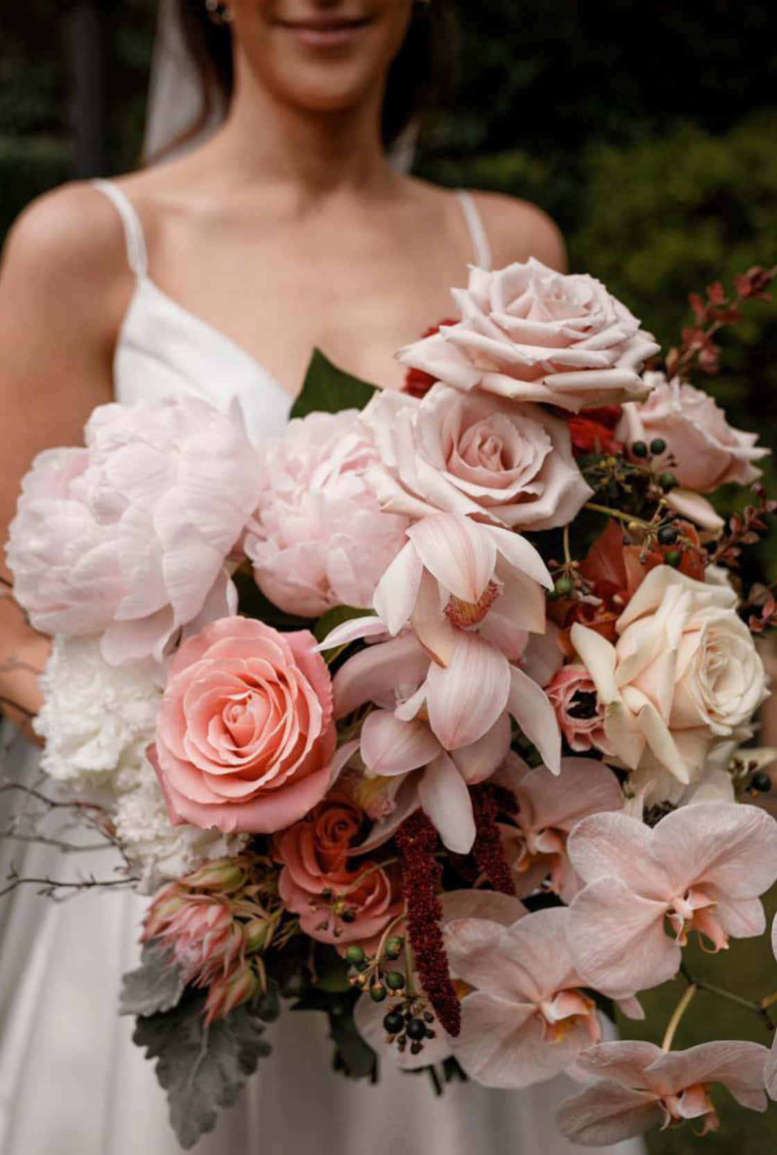 A Bride Holding A Pink And White Wedding Bouquet
