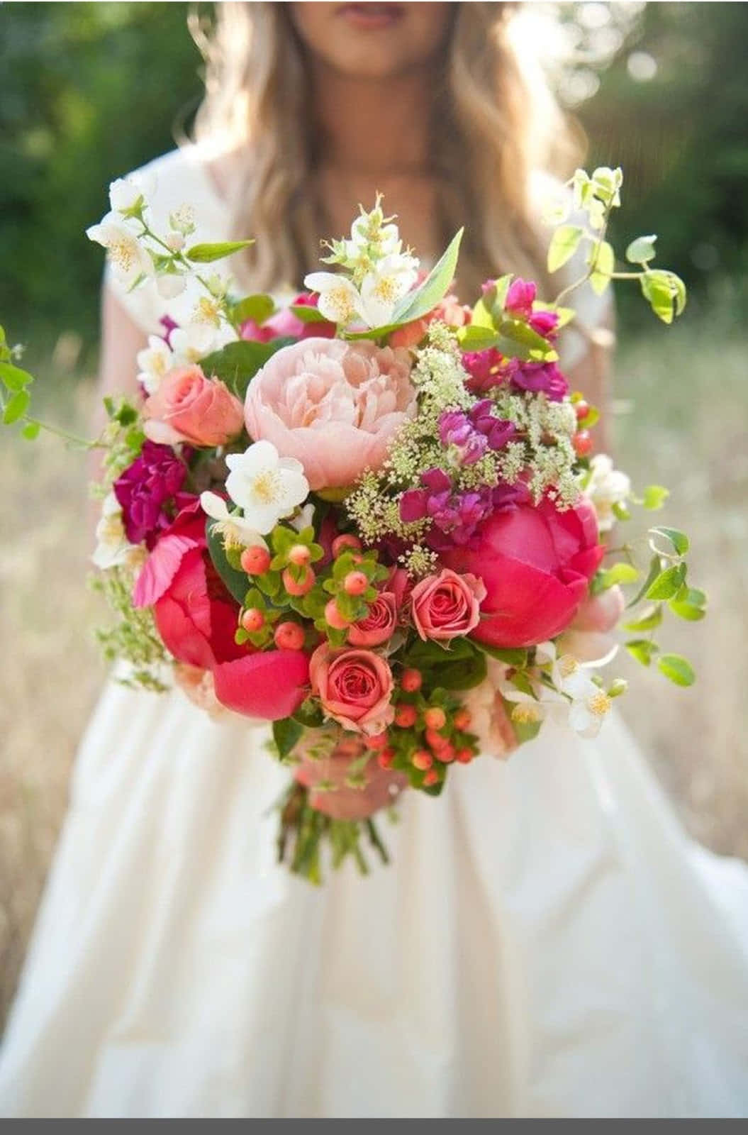 A Bride Holding A Bouquet Of Flowers