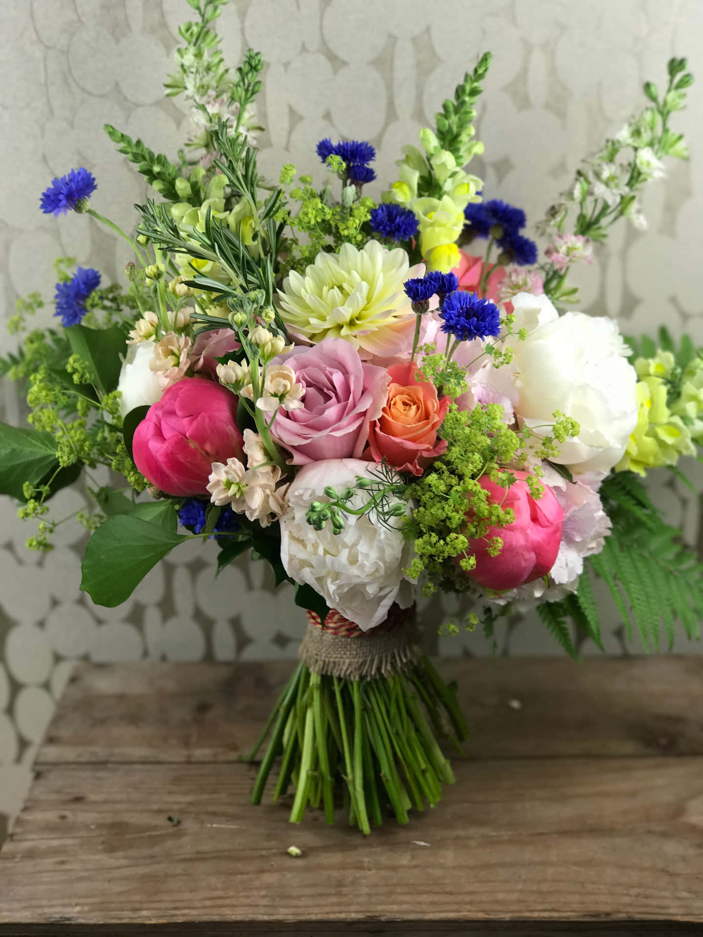 A Bouquet Of Flowers With Blue And Pink Flowers