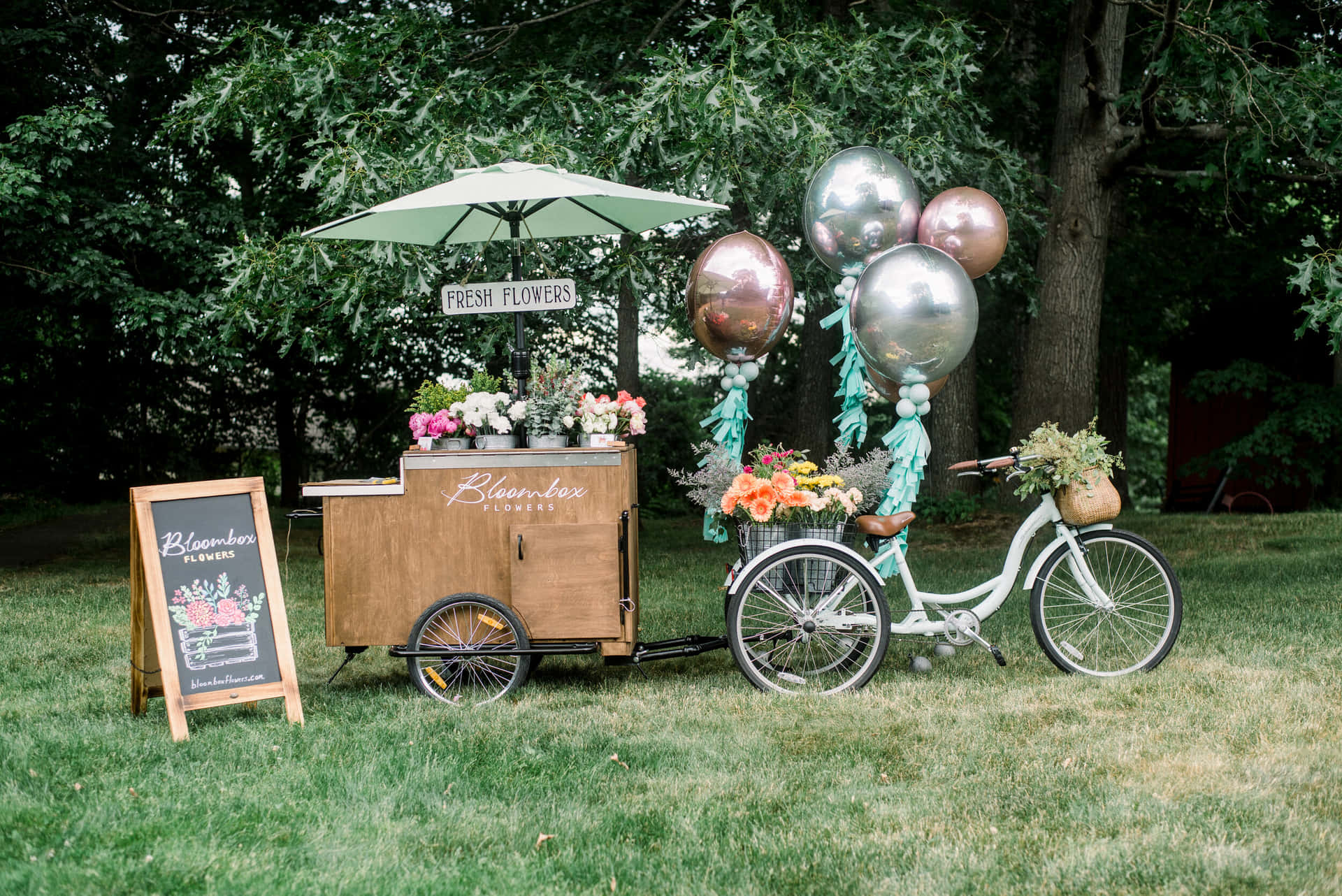 A vibrant flower cart filled with fresh spring blooms Wallpaper