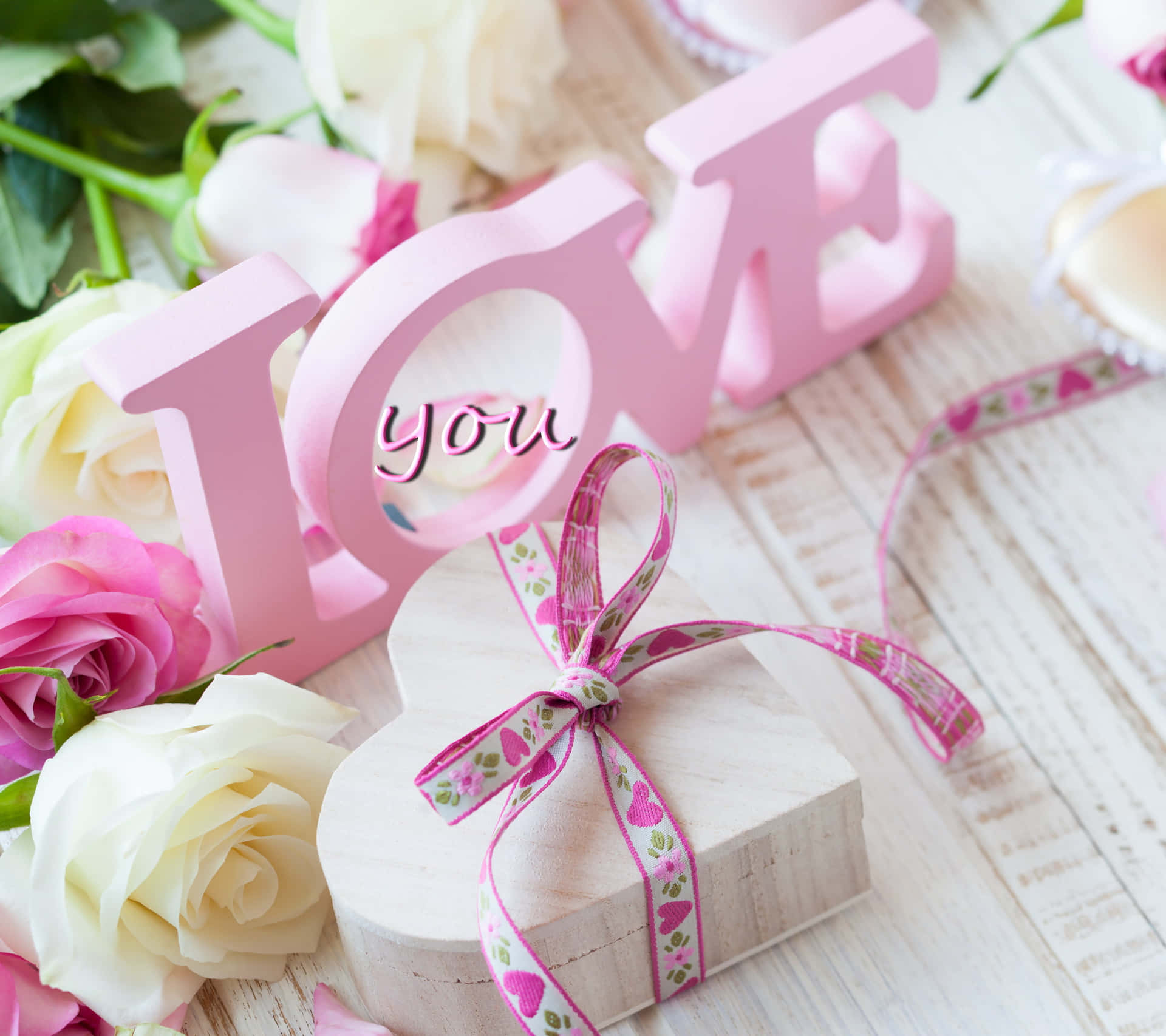 A Pink And White Heart Shaped Box With A Pink Ribbon