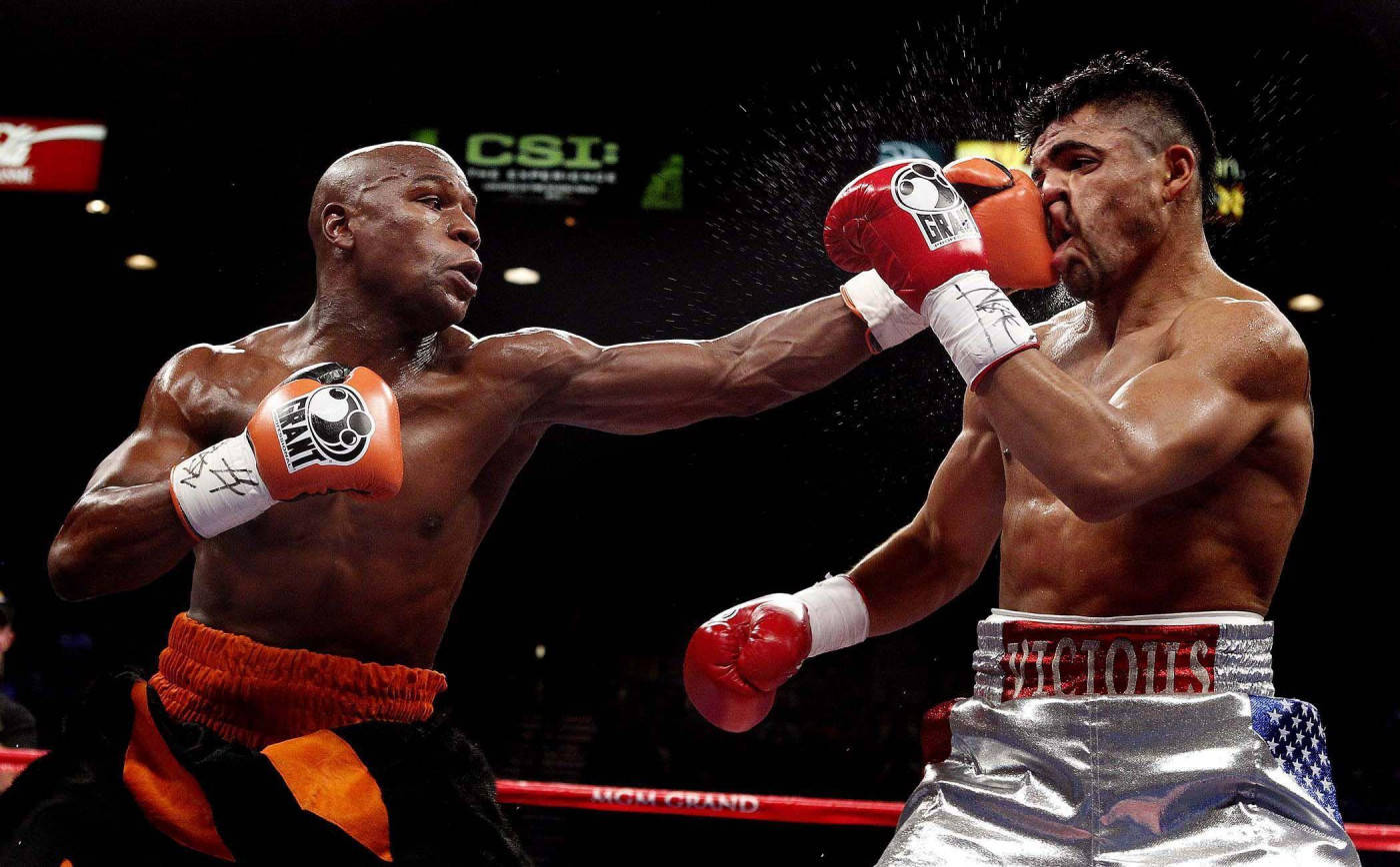 Floyd Mayweather Punching His Foe's Face Wallpaper
