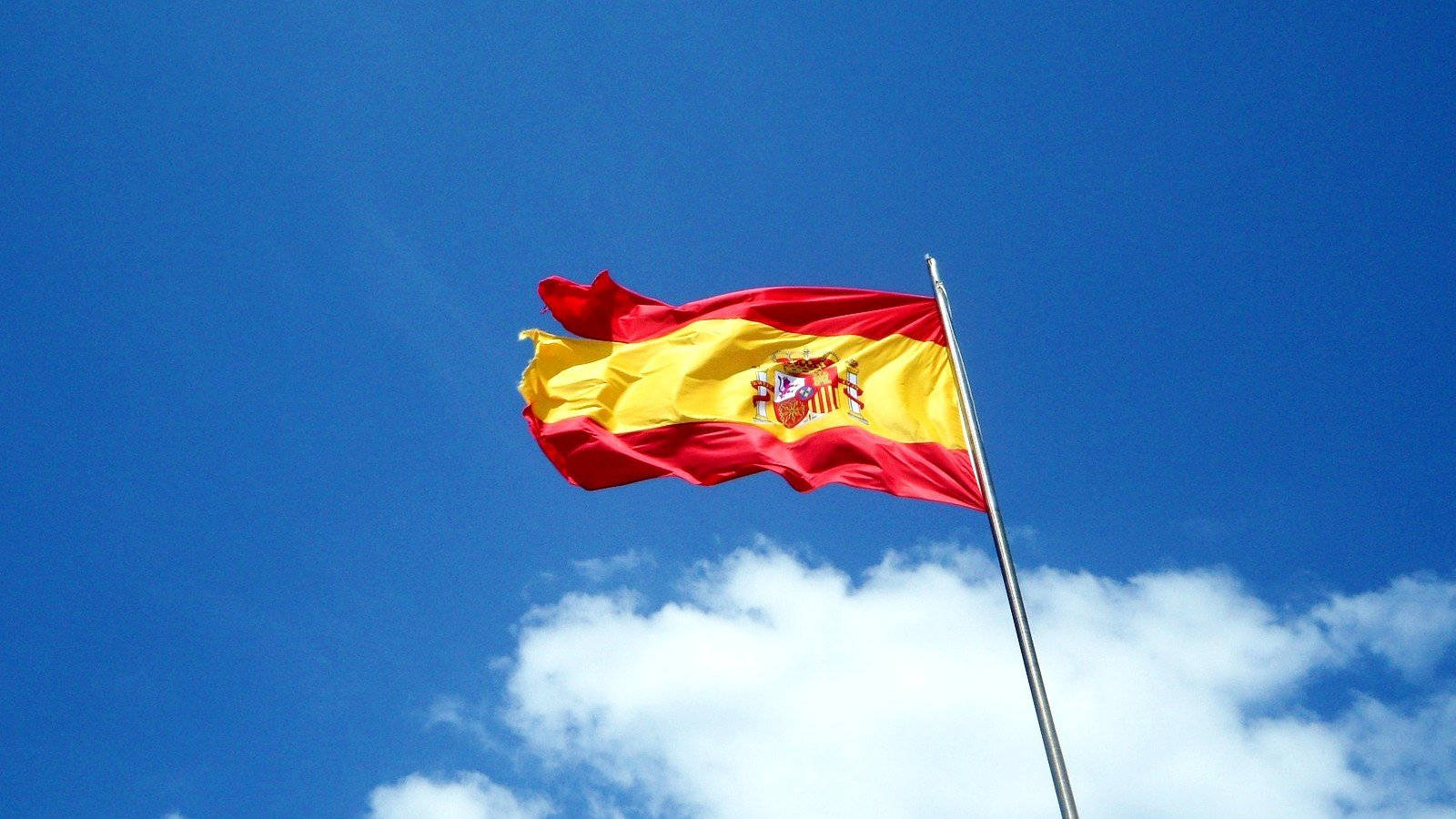 Flyvende skinnende spansk flag Wallpaper